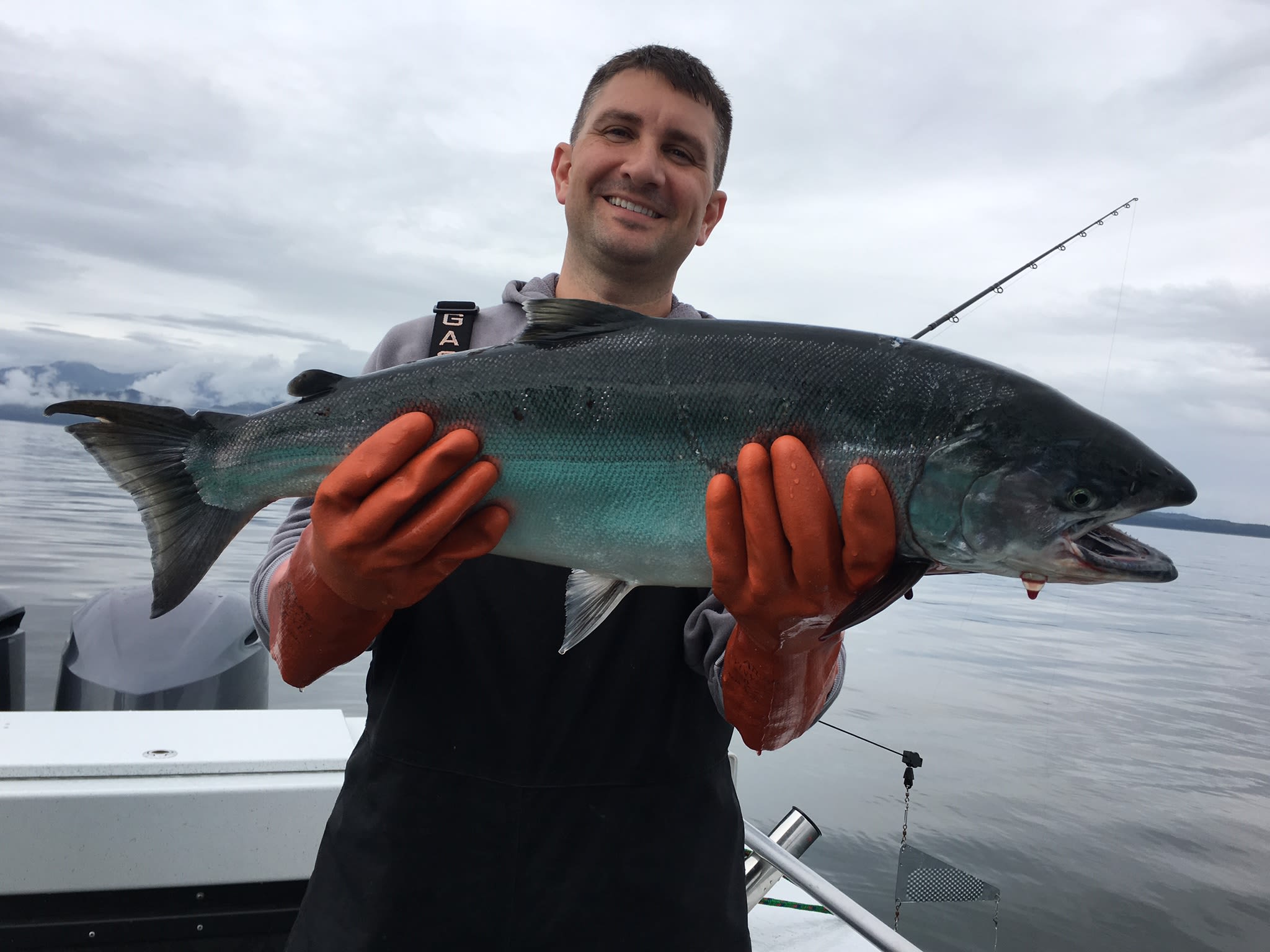 Tim from Touchmark Central Office in Beaverton, Oregon wshwoing off a King Salmon catch in Hoonah, Alaska