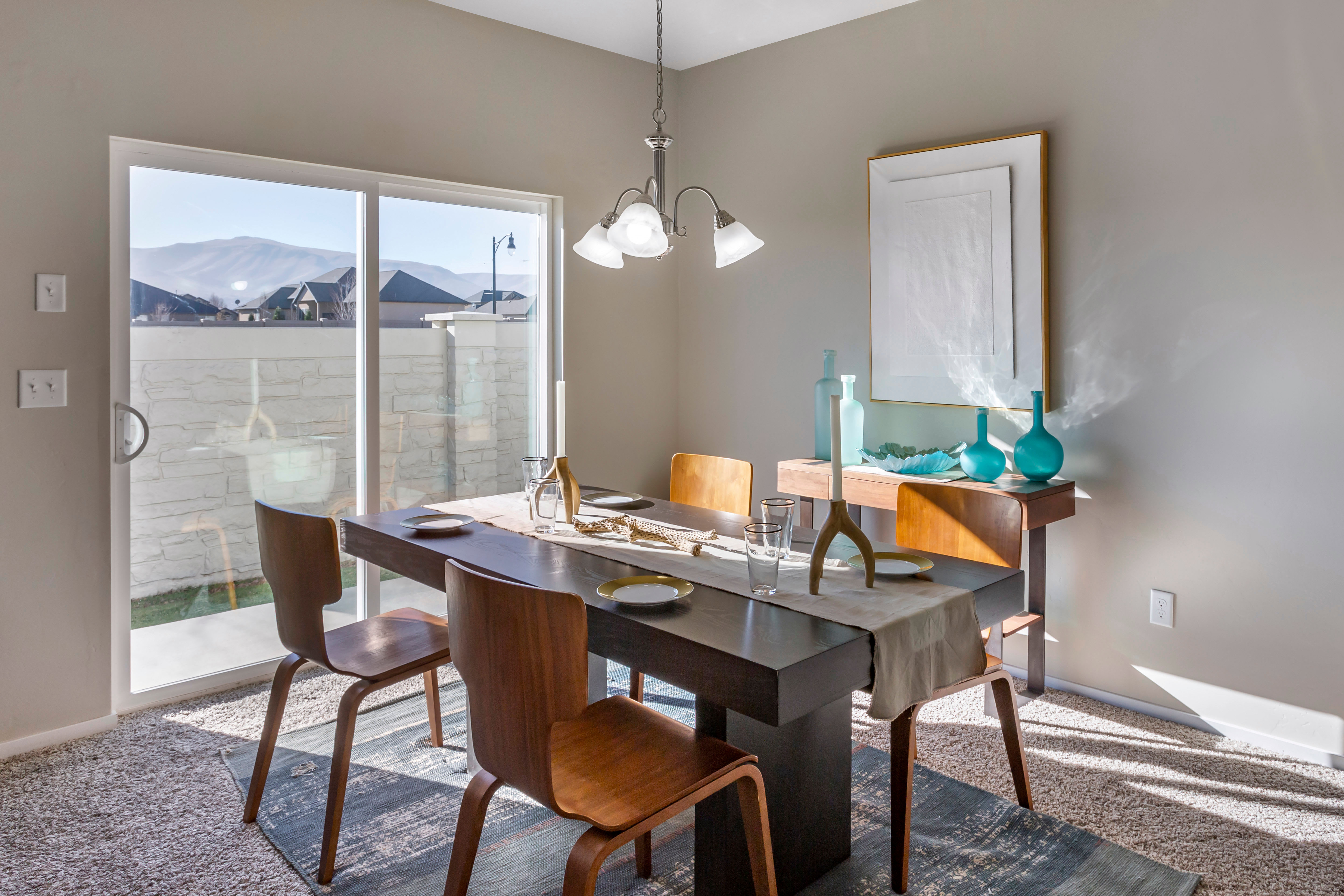 Model kitchen and dining area of a luxury townhome at Olympus at the Canyons in Herriman, Utah