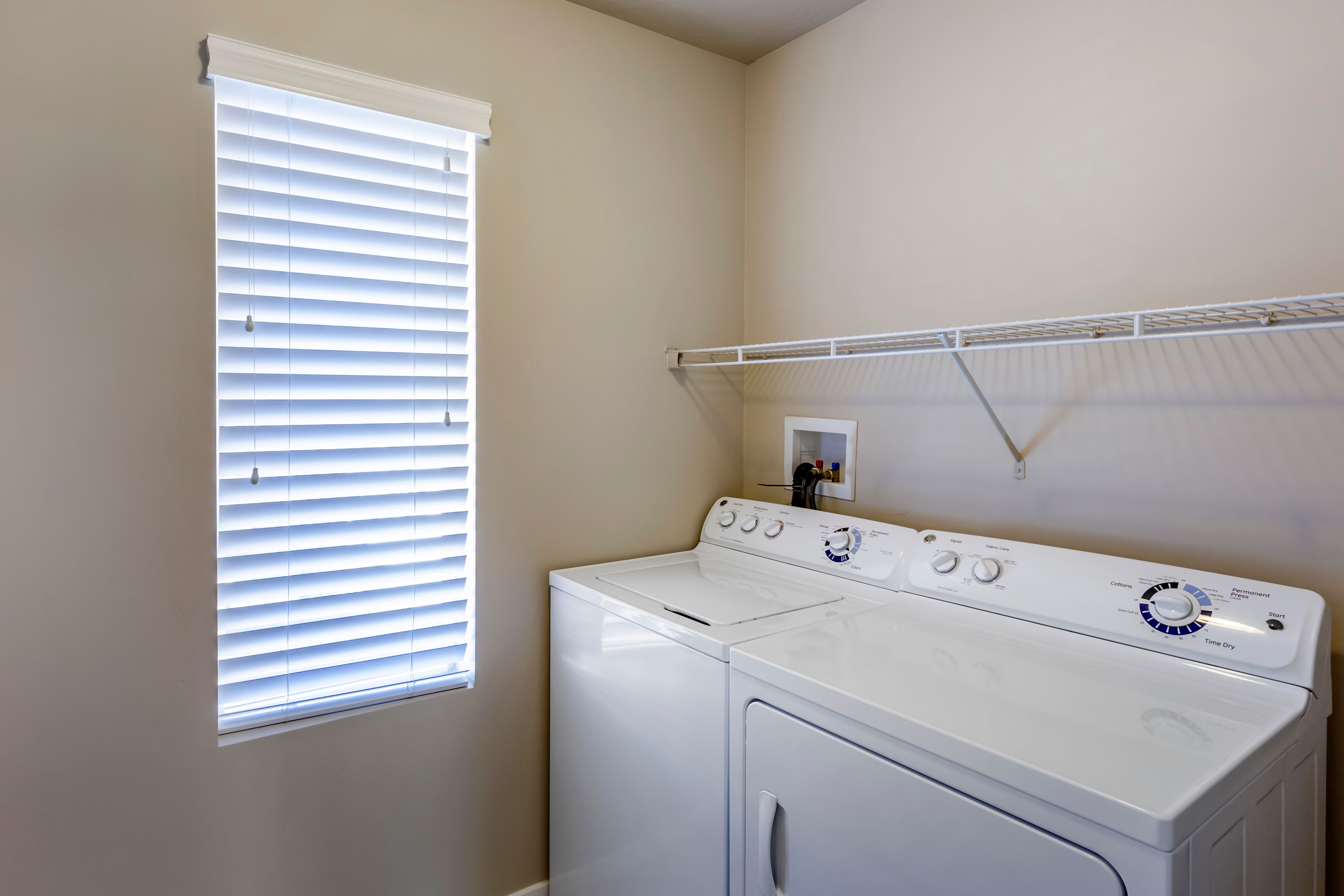 Full size washer and dryer in the laundry room of a home at Olympus at the Canyons in Herriman, Utah