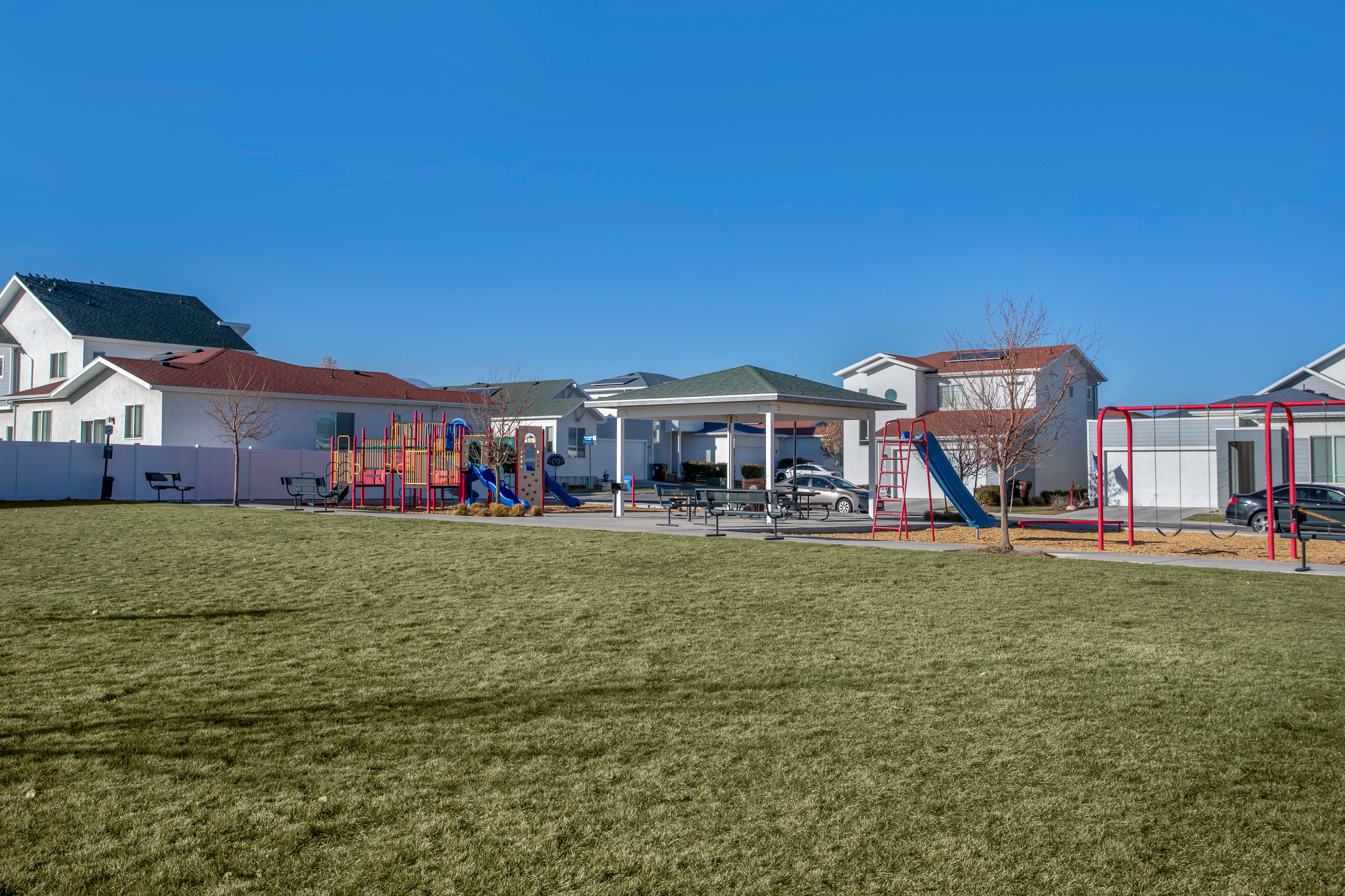 Two-story townhome with two-car attached garage and wide driveway at Olympus at the Canyons in Herriman, Utah