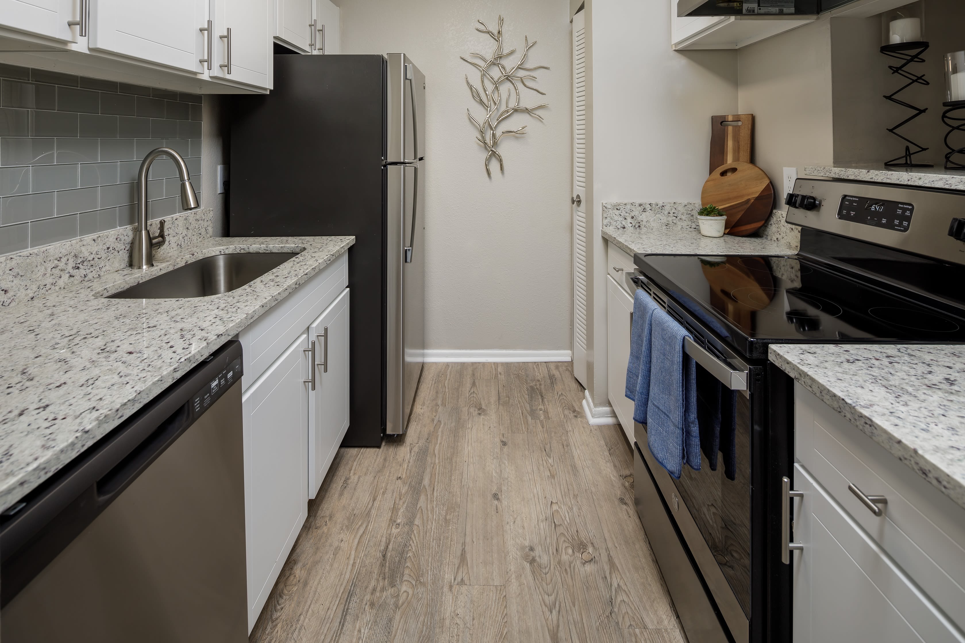 Updated appliances and countertops in a model home's kitchen at The Everette at East Cobb in Marietta, Georgia
