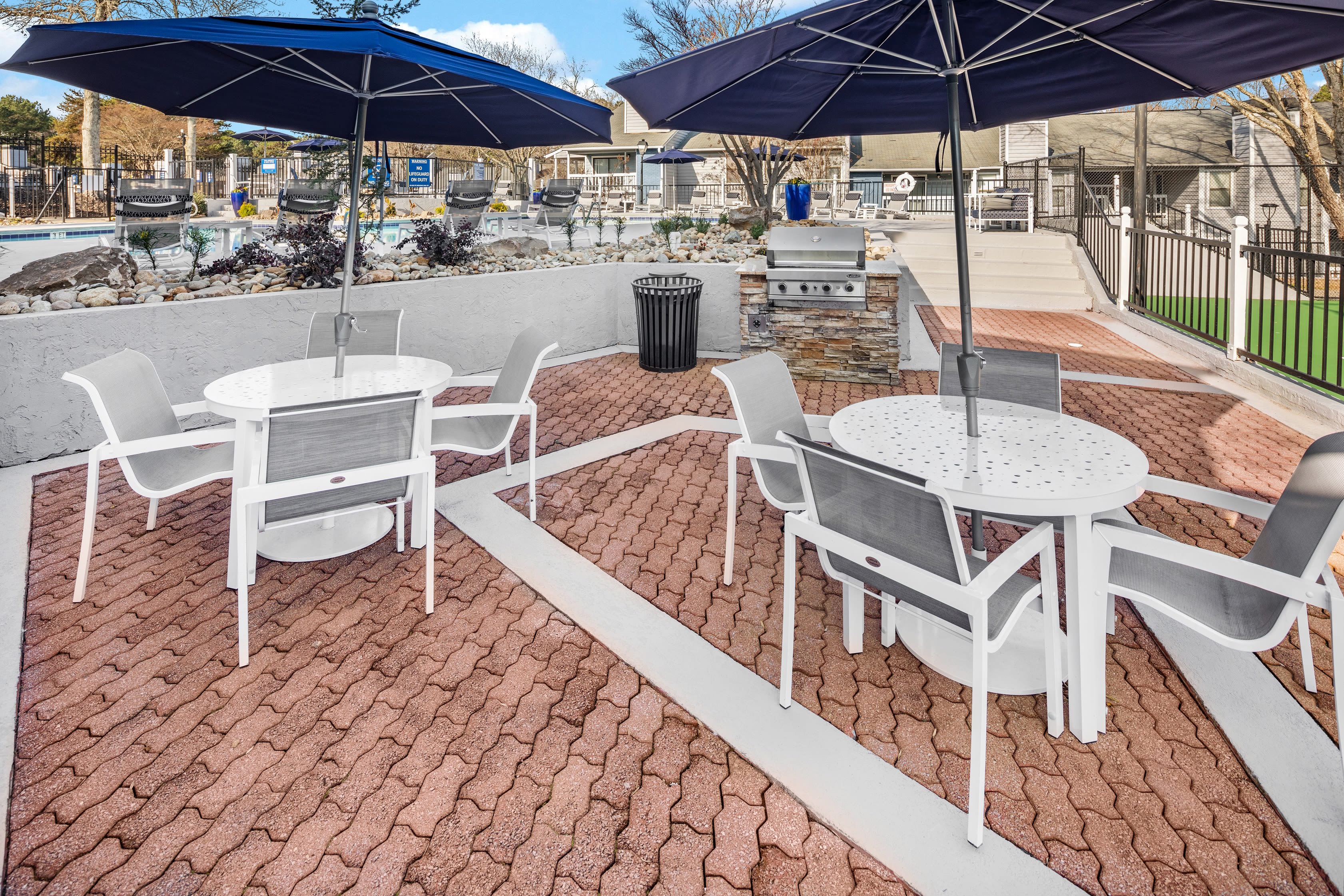 An outdoor seating area with tables and umbrellas at The Everette at East Cobb in Marietta, Georgia