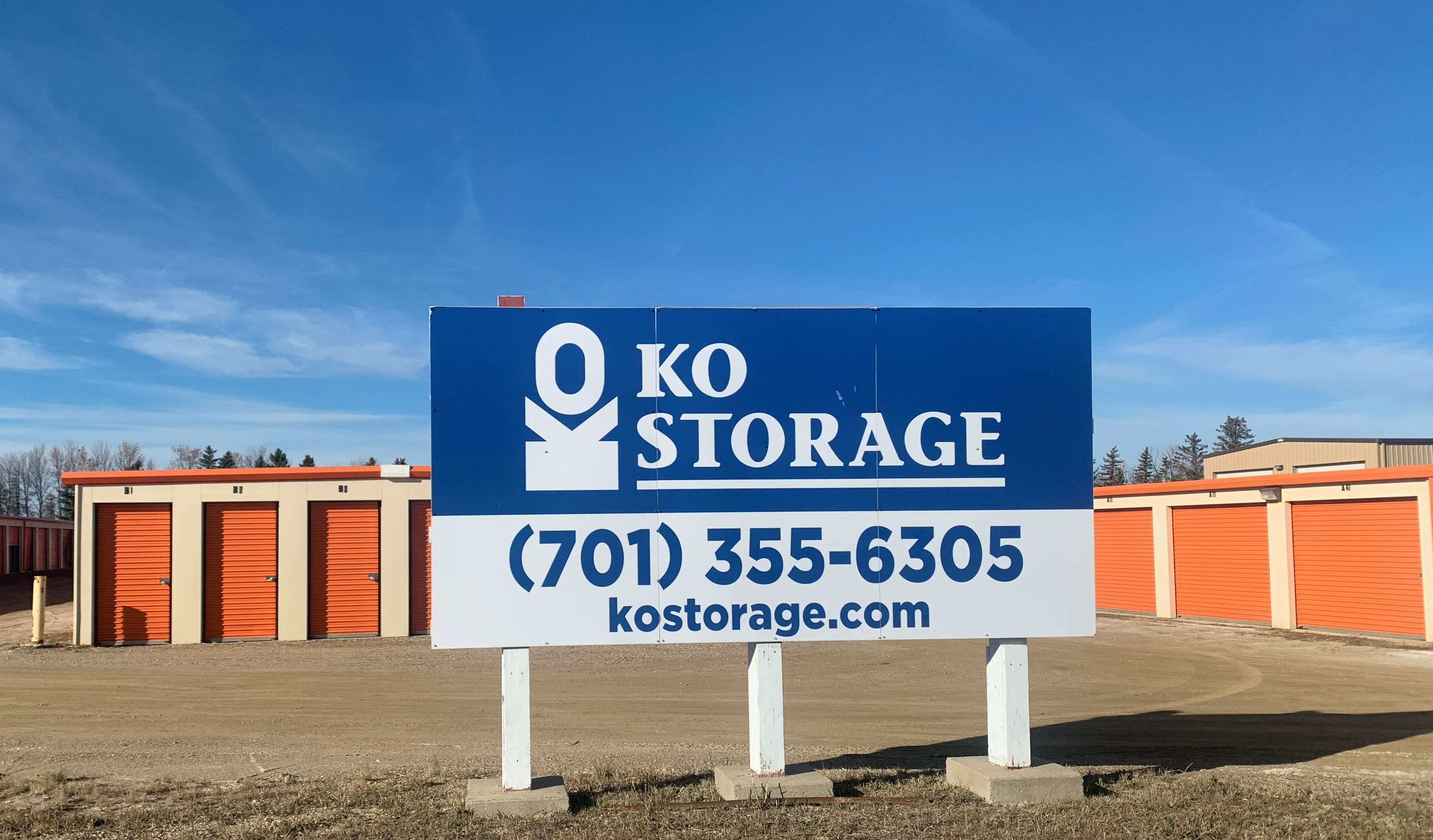 A man pushing a laughing child in a box near KO Storage of Minot - North in Minot, North Dakota