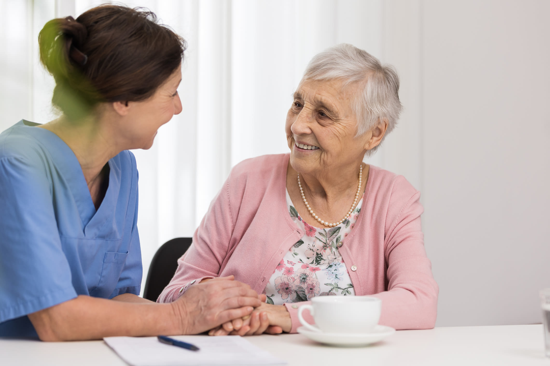 Resident talking with staff at The Woodmark at Daytona Beach in Daytona Beach, Florida