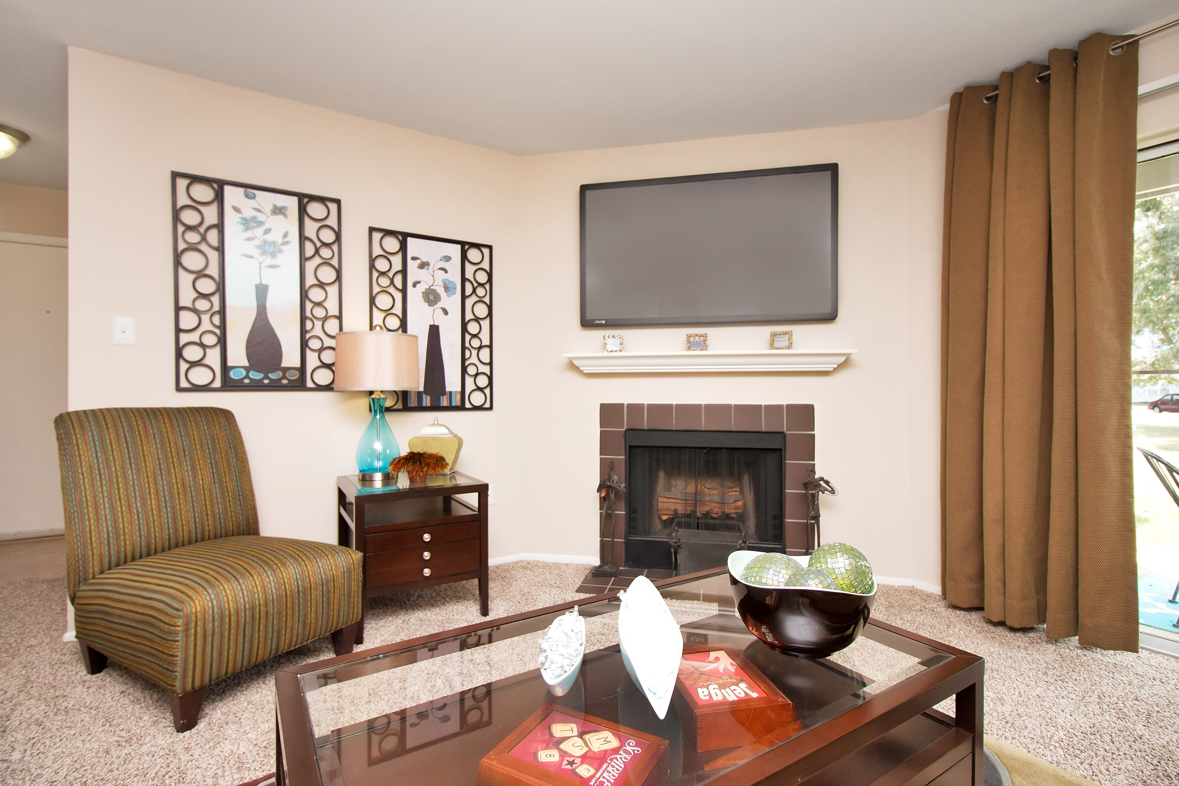 Living room with fireplace at Runaway Bay Apartments in Virginia Beach, Virginia