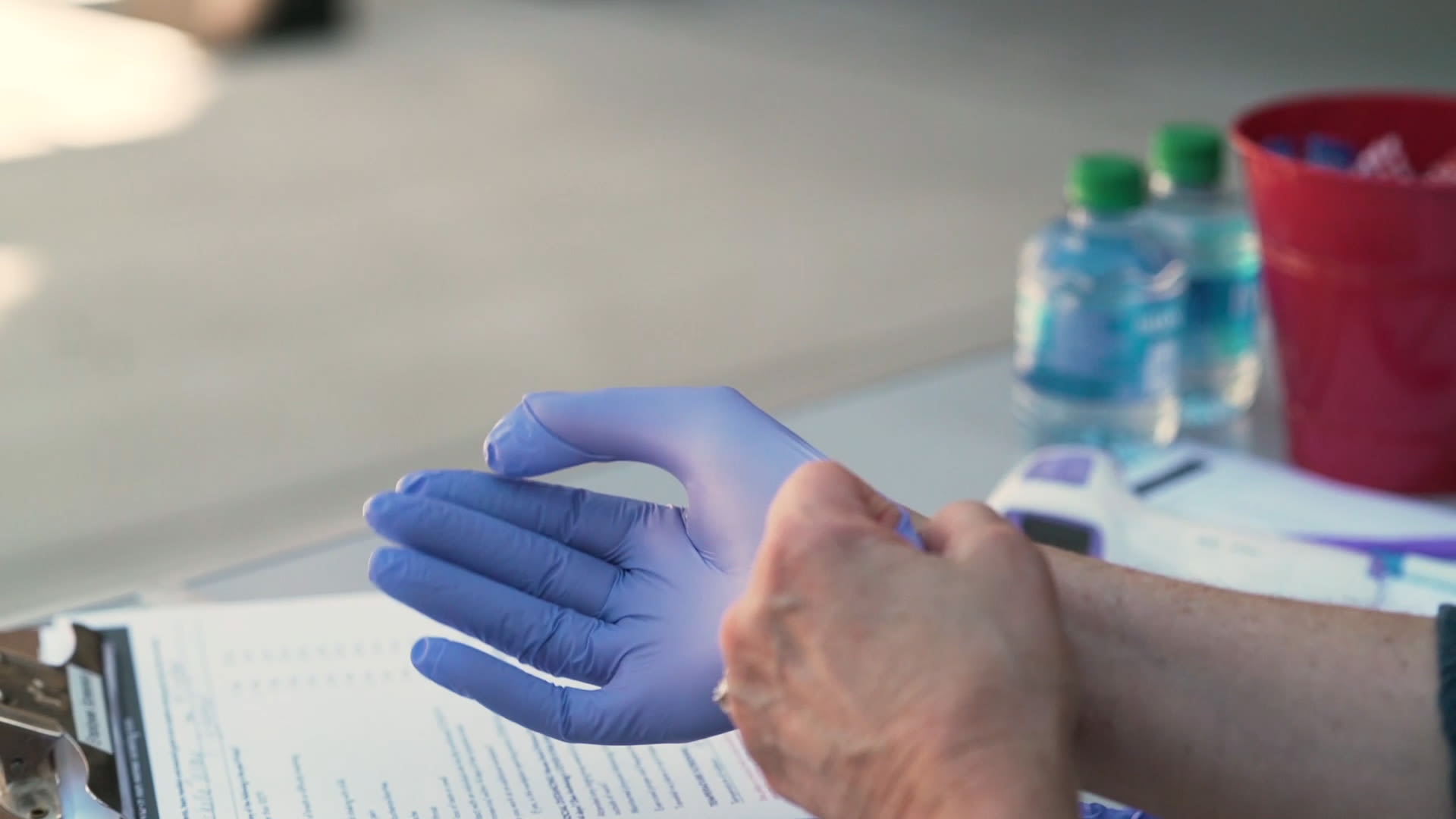 Caretaker putting gloves on at a Anthology of Grayslake community