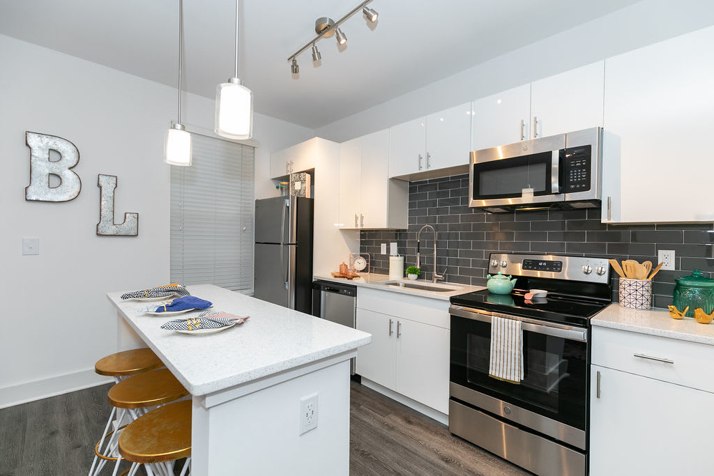 Open kitchen with stainless-steel appliances at Block Lofts in Atlanta, GA