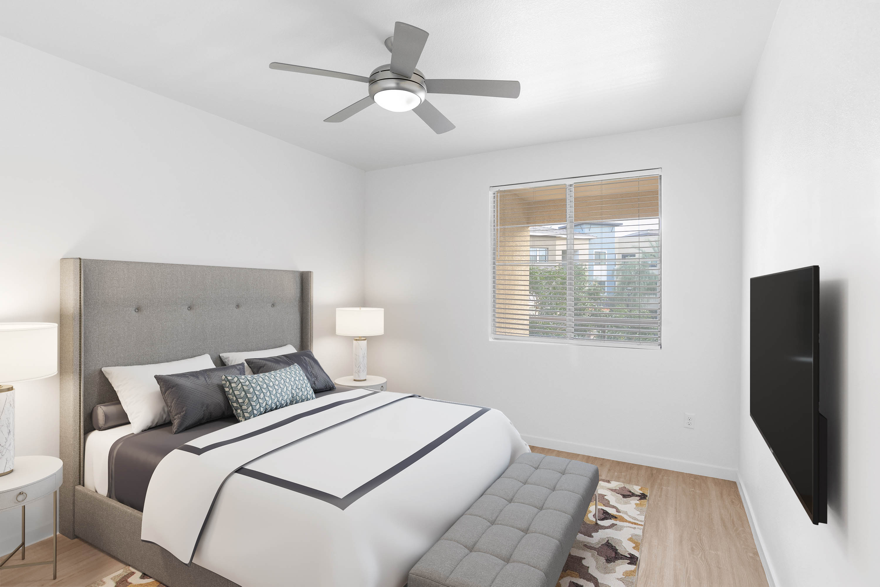 Modern furnishings and plush carpeting in a model home's primary bedroom at Vistara at SanTan Village in Gilbert, Arizona