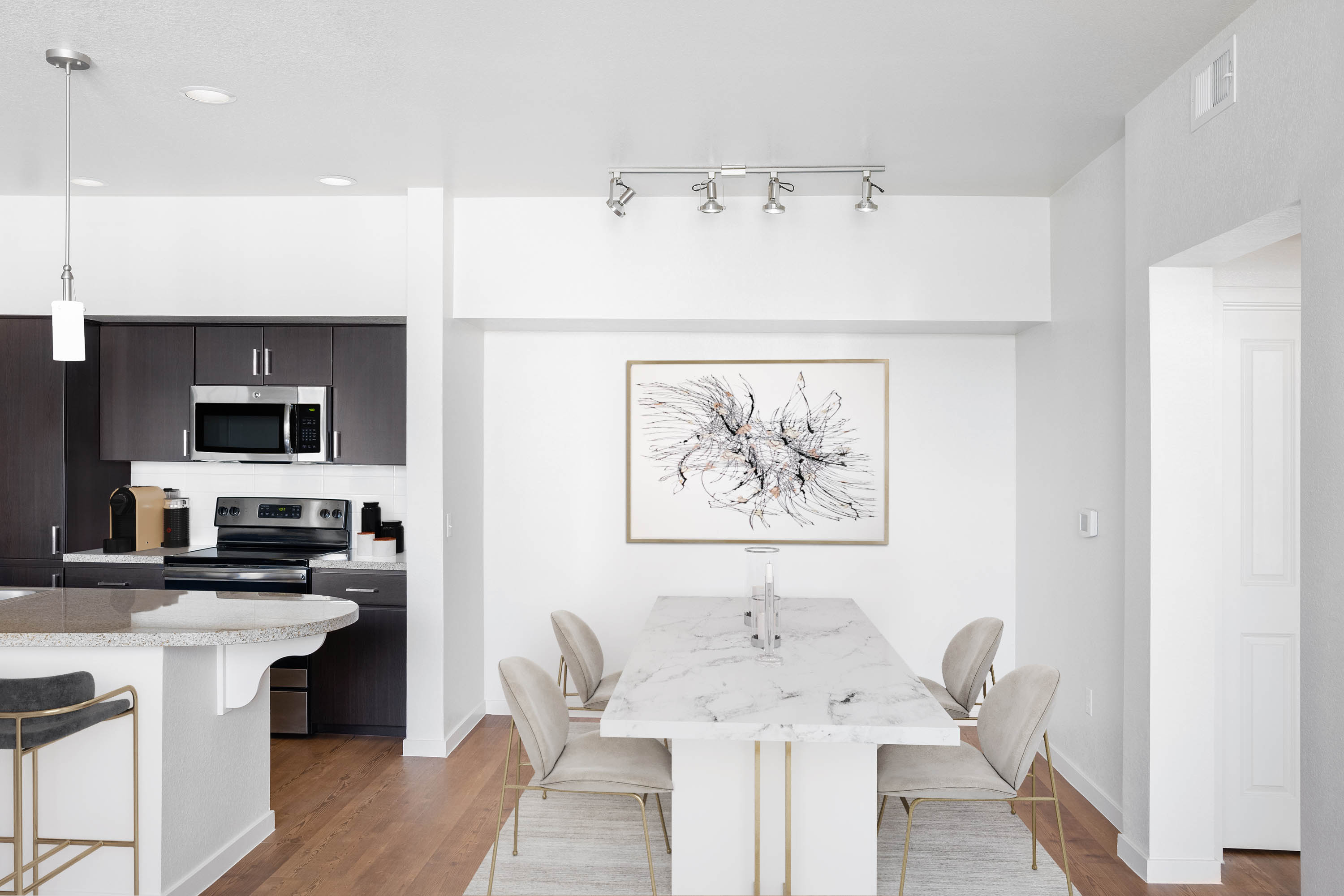 Spacious open-concept layout with beautiful hardwood flooring in a model home at Vistara at SanTan Village in Gilbert, Arizona