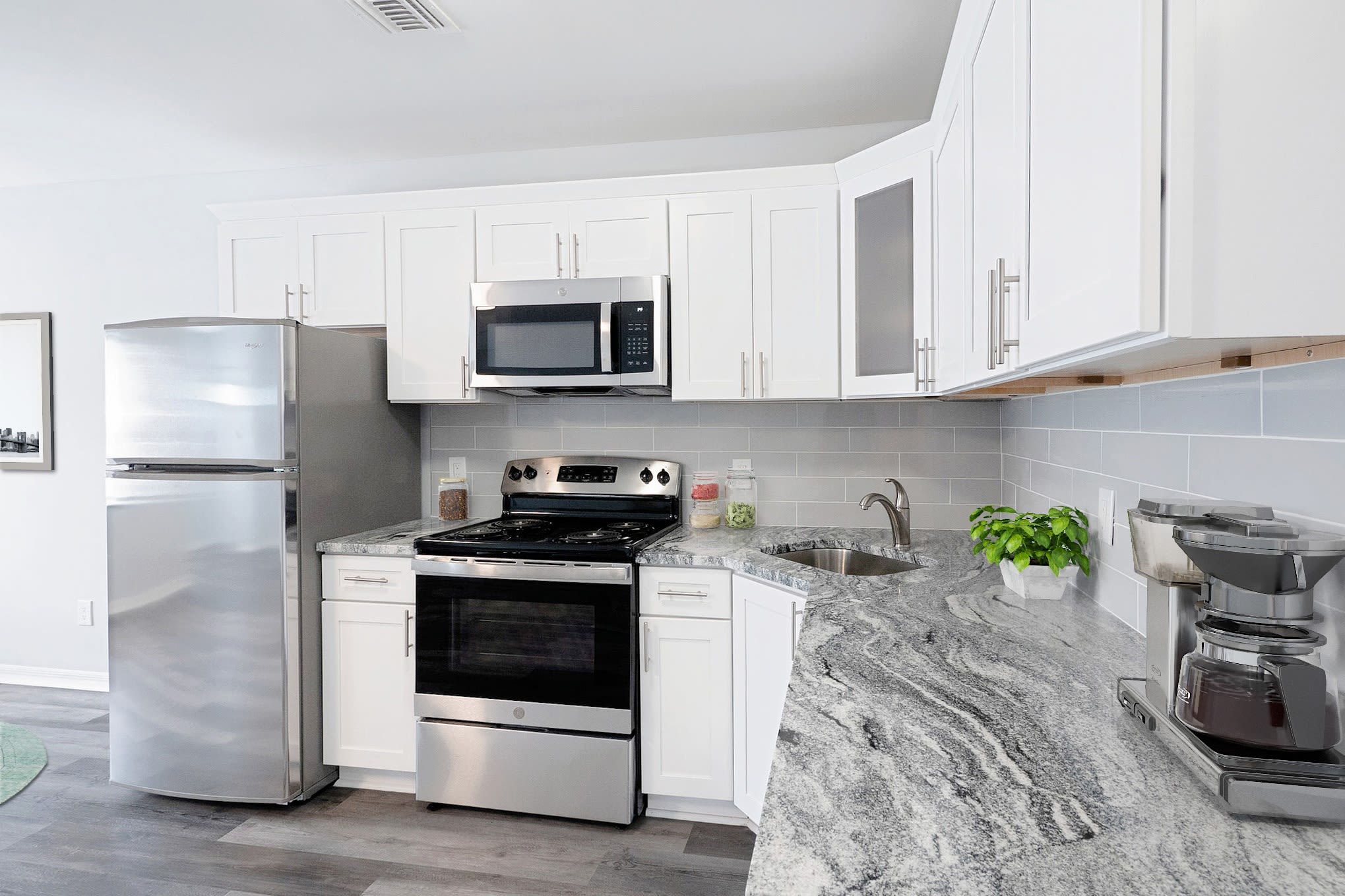 Kitchen with modern appliances at Bunt Commons II in Copiague, New York
