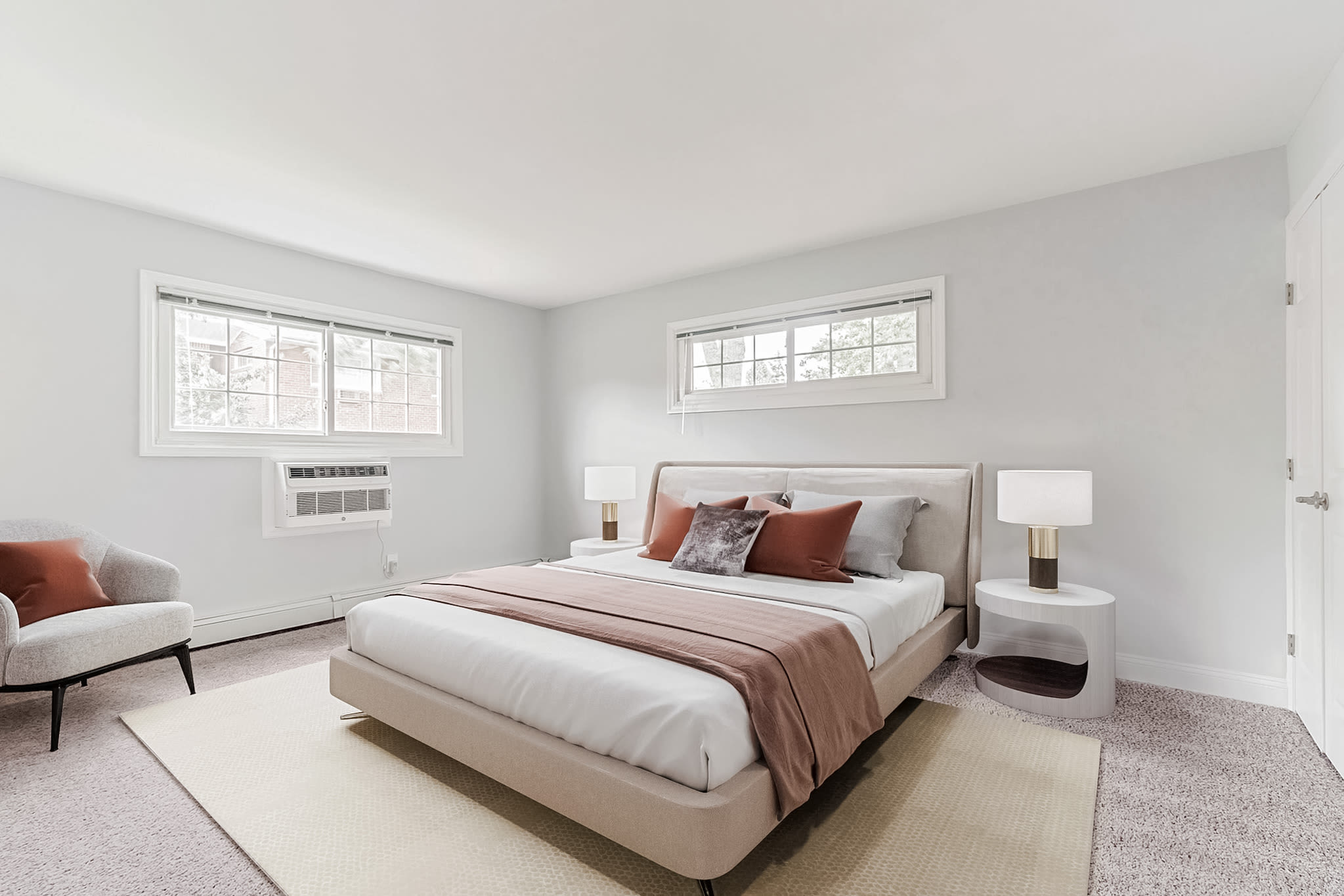 Large master bedroom with windows at Eagle Rock Apartments at Mineola in Mineola, New York