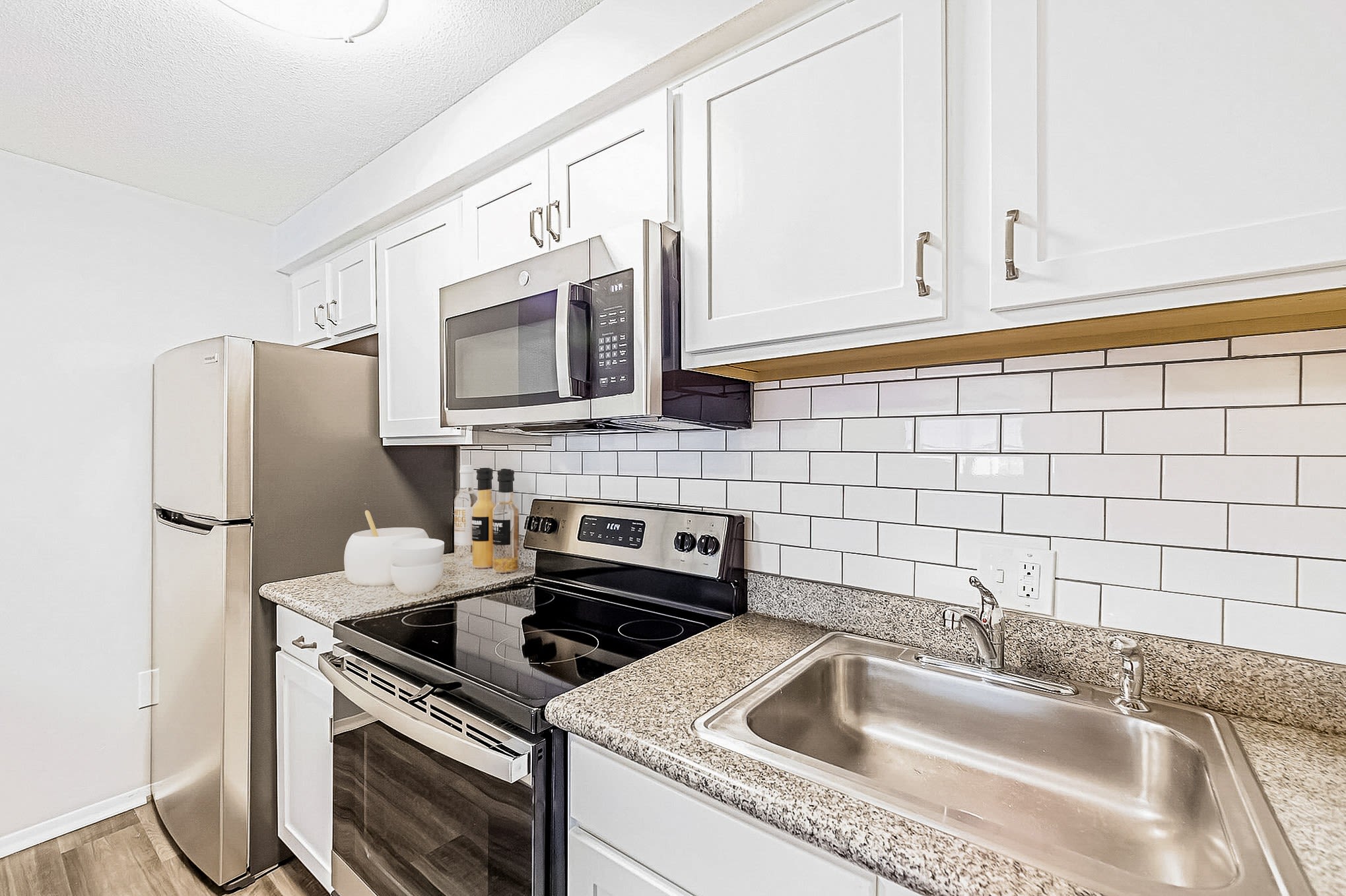 Kitchen with detailed backsplash at Eagle Rock Apartments at Nashua in Nashua, New Hampshire