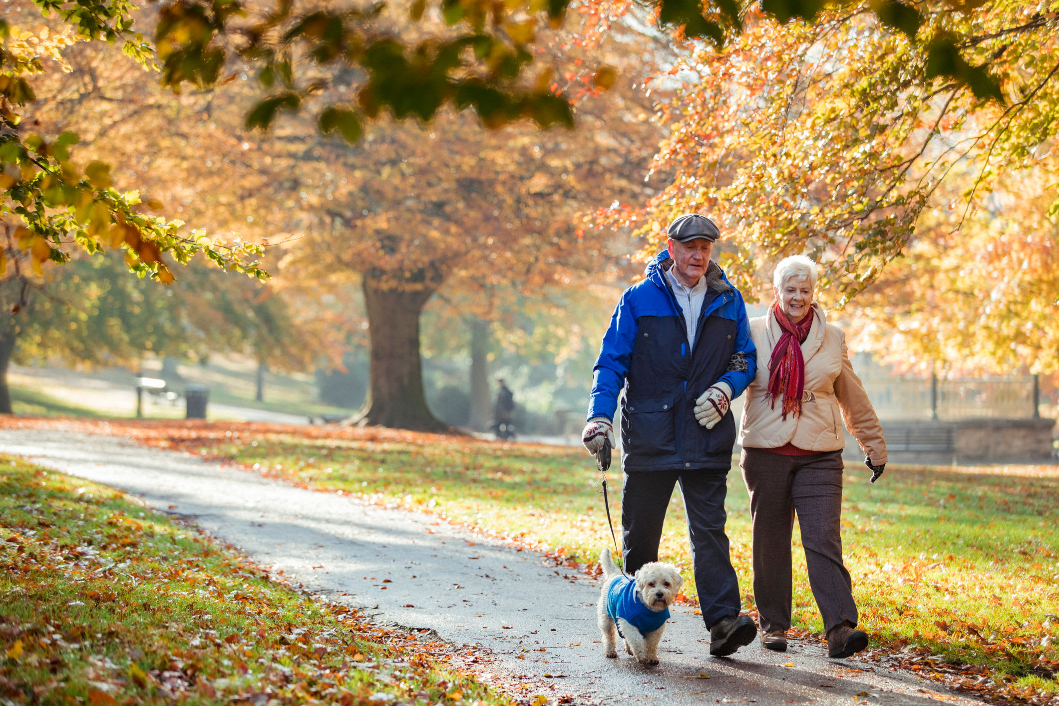 Resident couple walking a dog at English Meadows Laurens Campus in Laurens, South Carolina