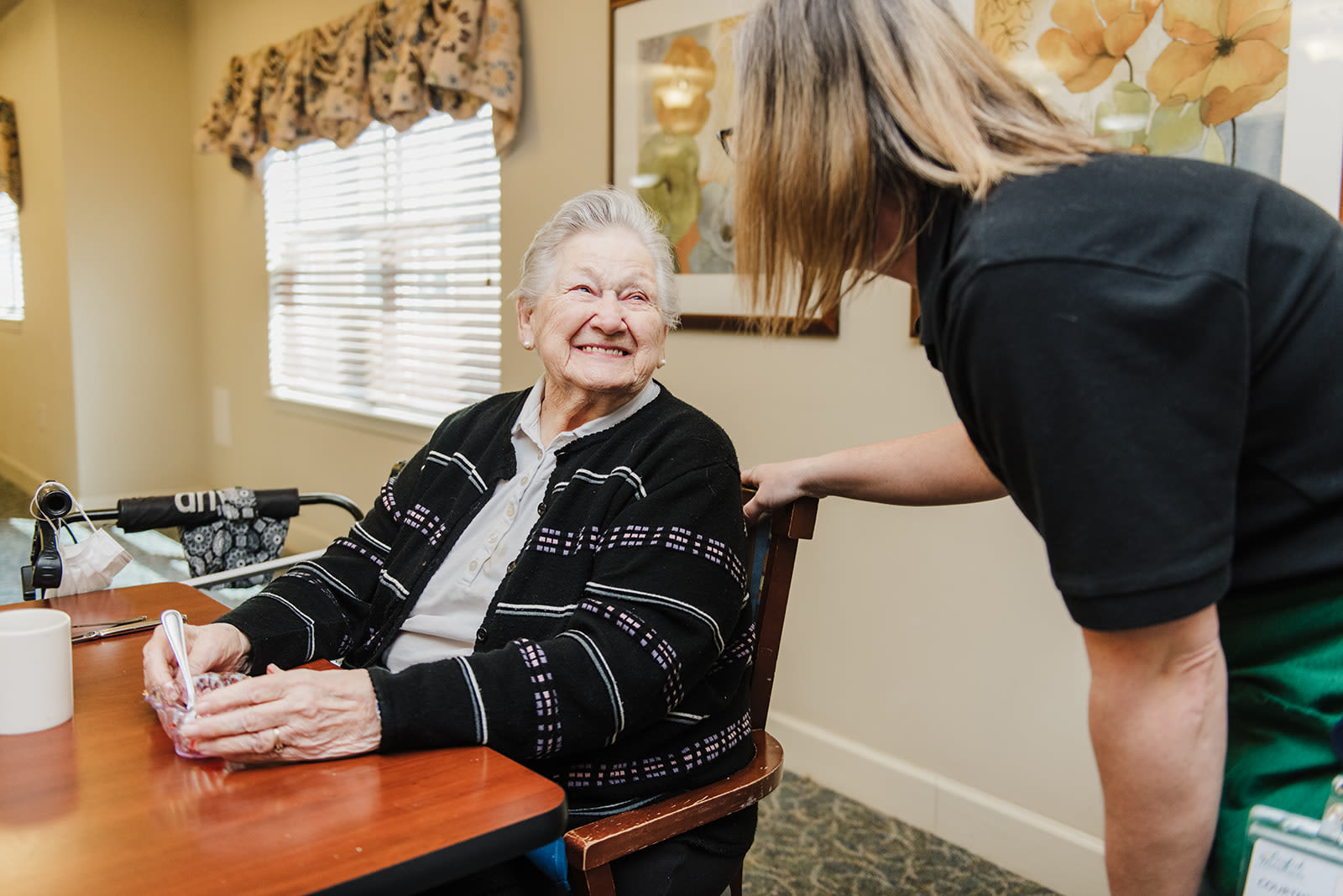 Caretaker talking to a resident at English Meadows Conway Campus in Conway, South Carolina