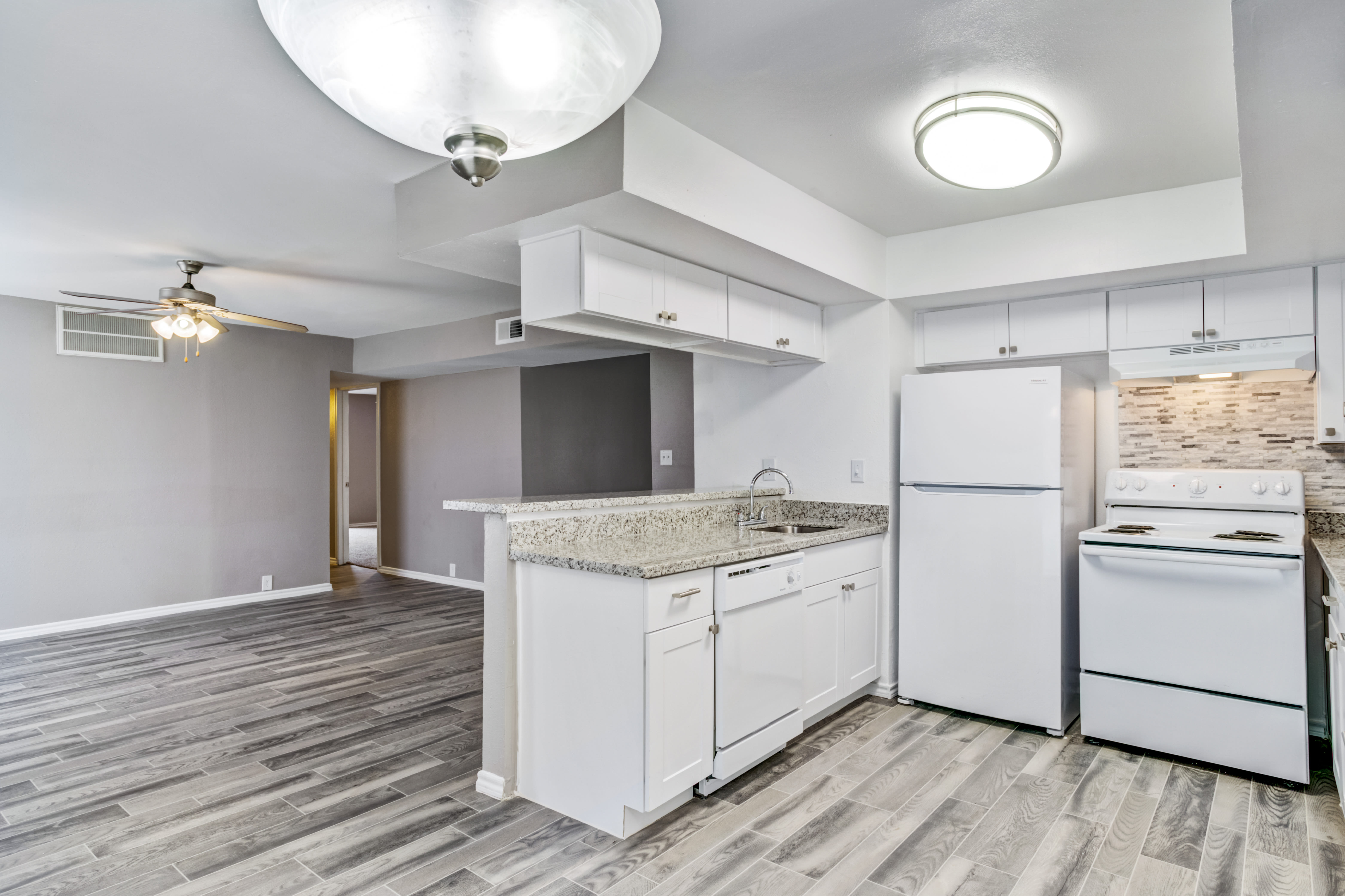 Kitchen with granite counters at Country Woods in Houston, Texas