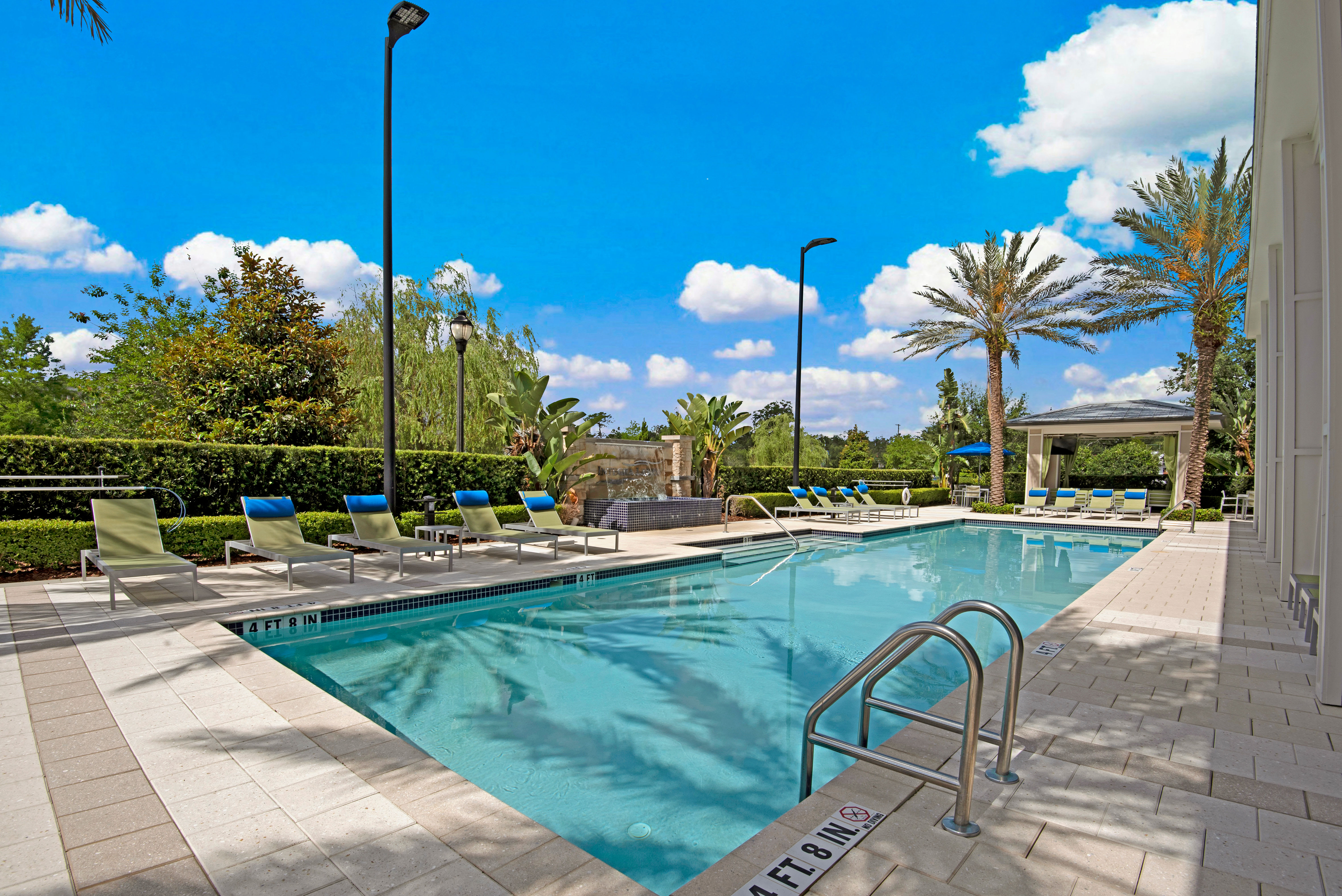 Outdoor pool lounging area at Integra Lakes in Casselberry, Florida
