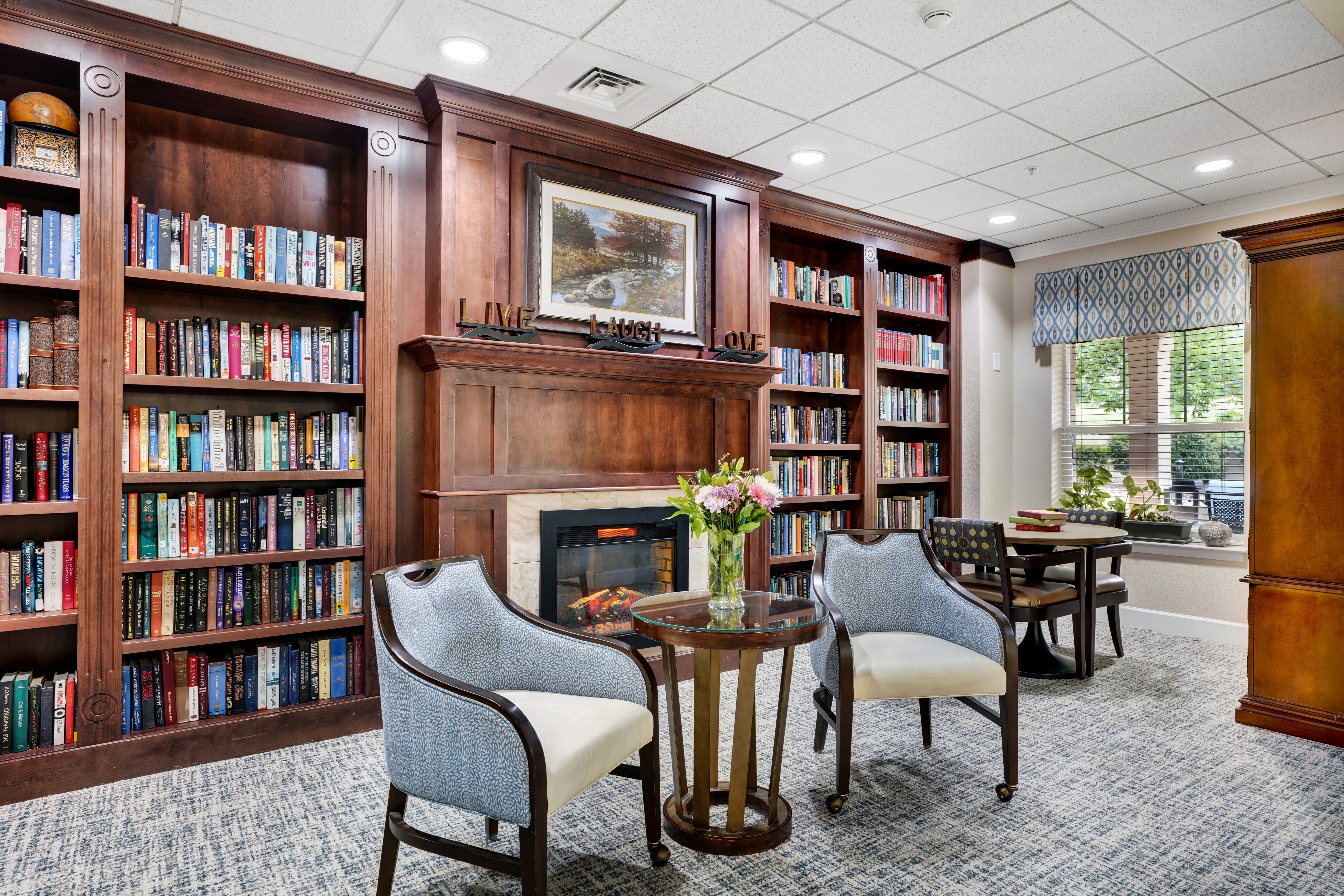 Elegant sitting area with bookcases at The Inn at Greenwood Village in Greenwood Village, Colorado