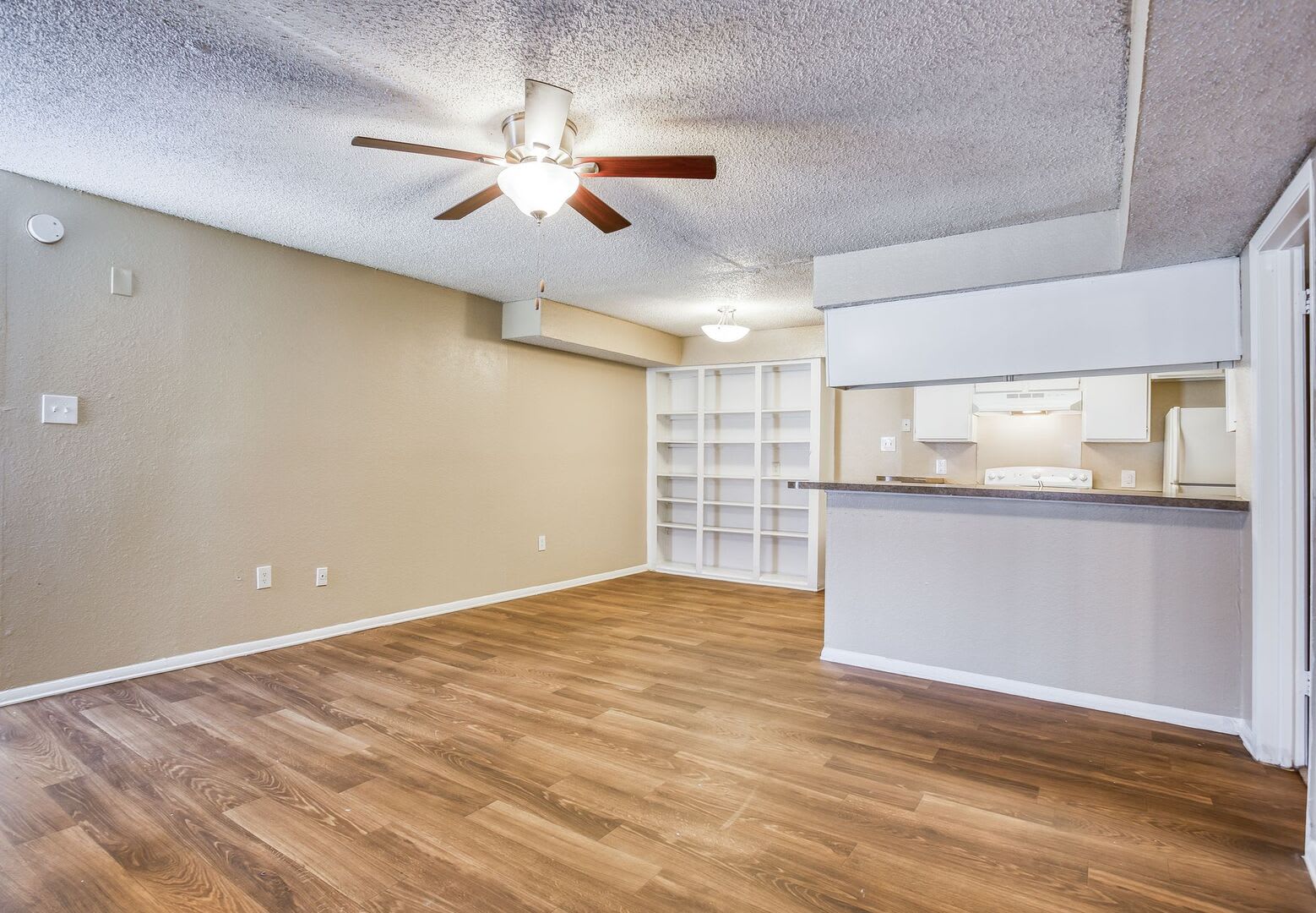 Inside an apartment home with wood style flooring at Santa Fe Apartment Homes in Dallas, Texas