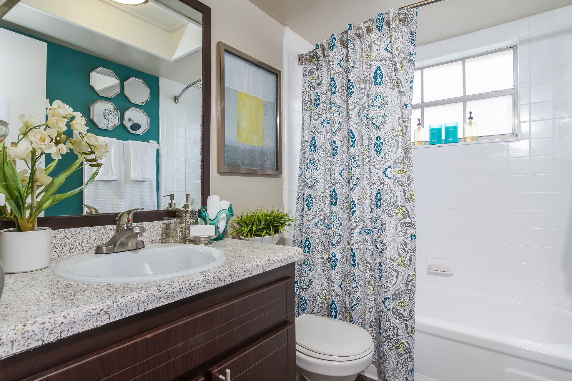 Apartment bathroom with a large vanity and tub/shower combination at Central Place at Winter Park in Winter Park, Florida
