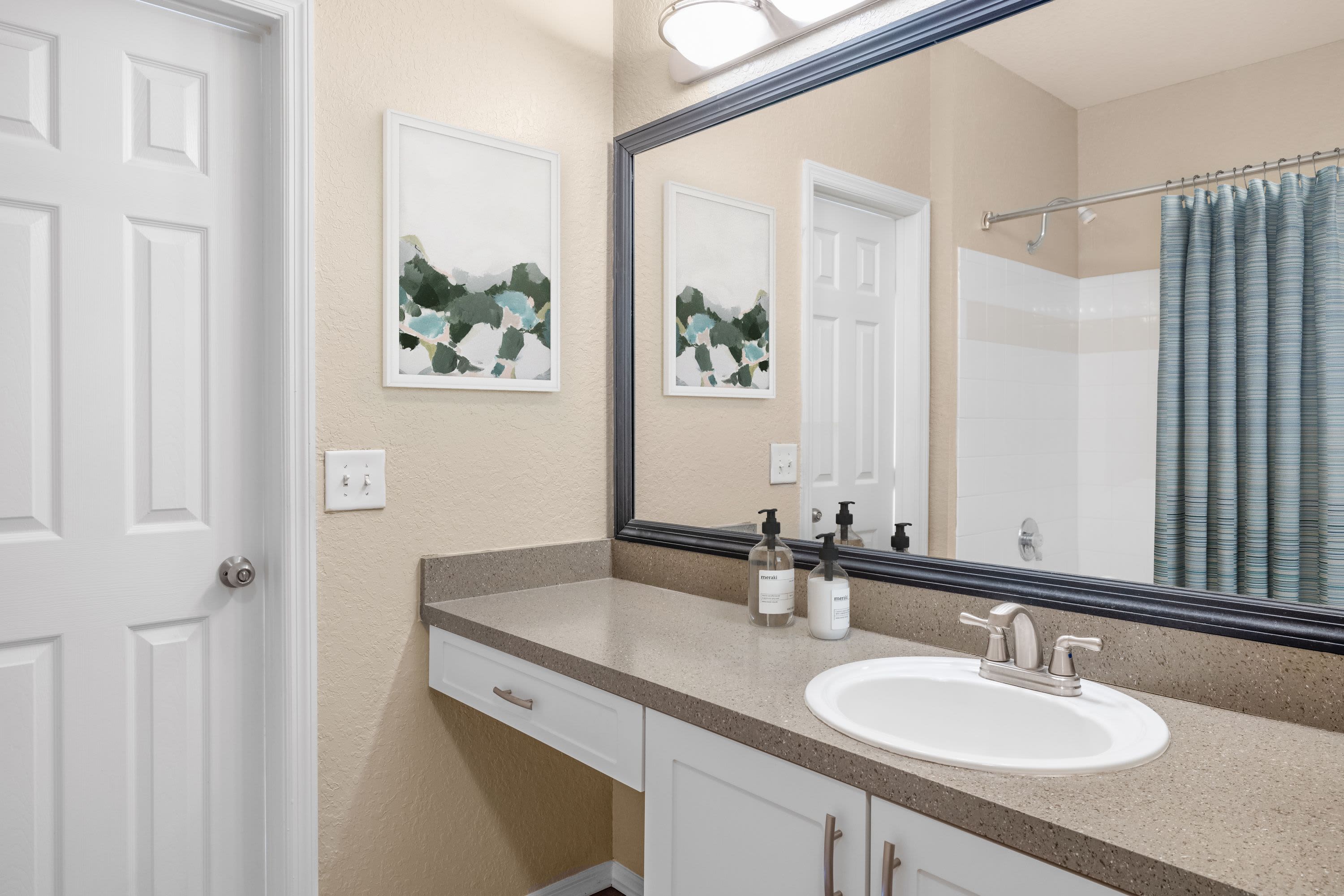 Bathroom with a large mirror at Verandahs of Brighton Bay | Apartments & Townhomes in St. Petersburg, Florida