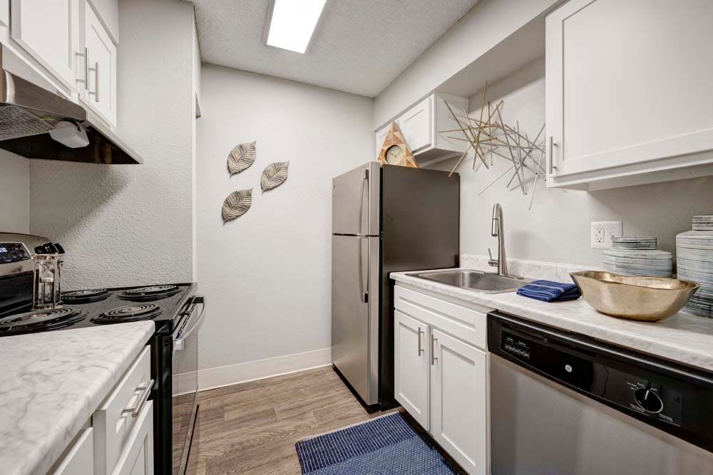 State-of-the-art kitchen featuring stainless steel appliances at Hampden Heights Apartments in Denver, Colorado