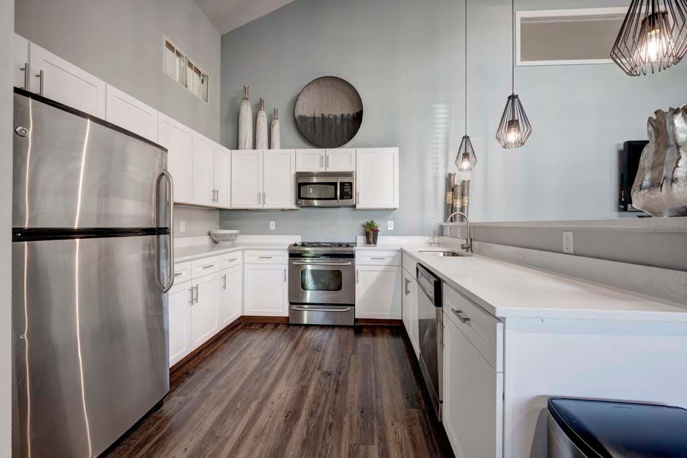 Community gathering space with shared kitchen in clubhouse at Hampden Heights Apartments in Denver, Colorado