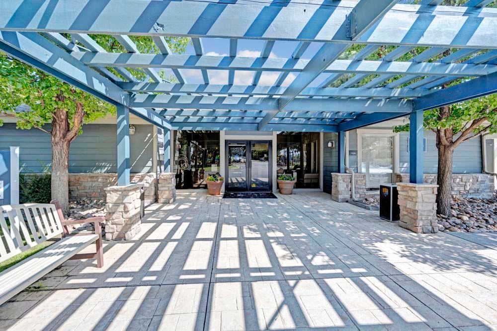 Outdoor lounge area with beautiful blue pergola at Hampden Heights Apartments in Denver, Colorado