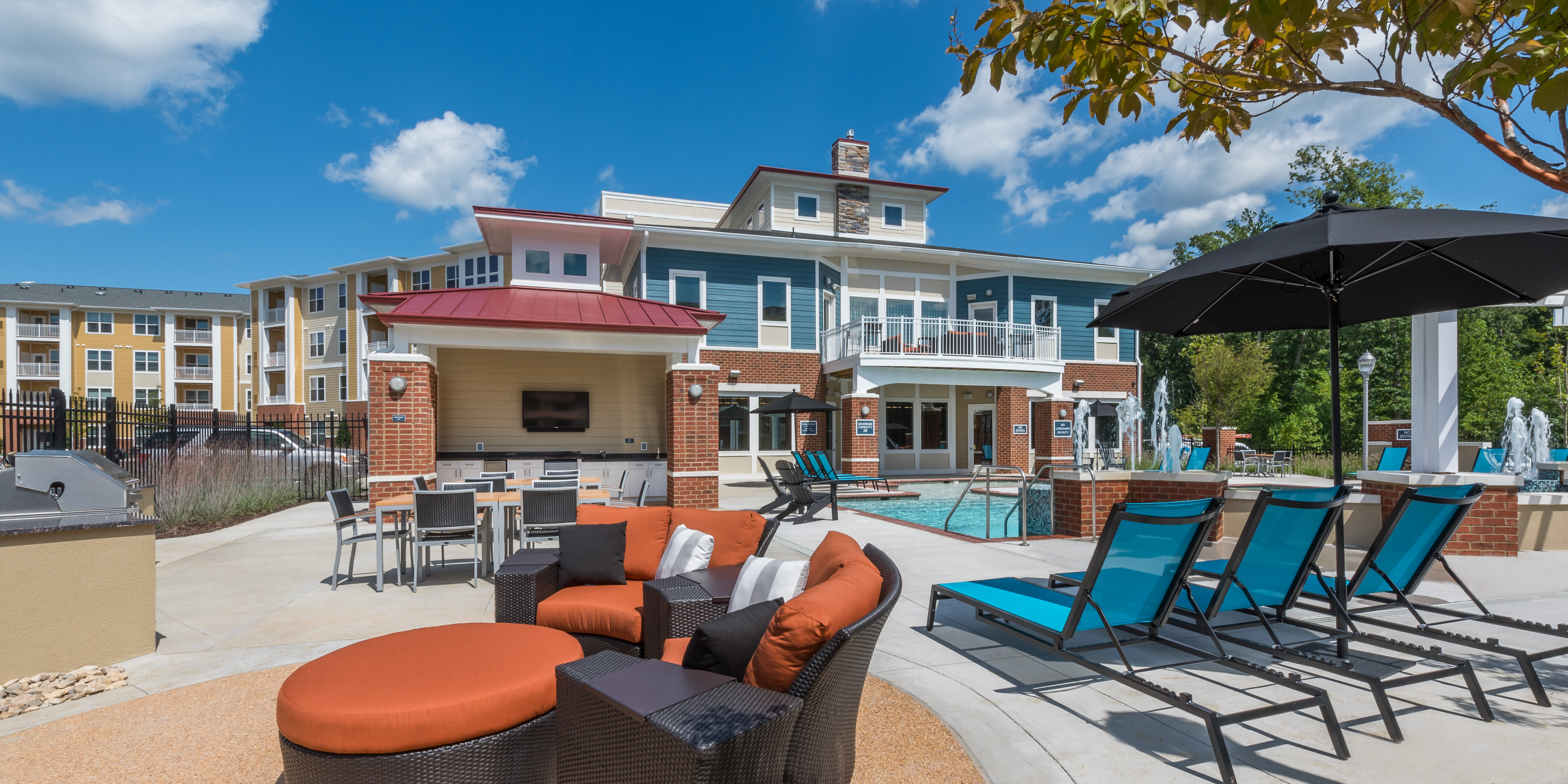 Resort-style pool with stylish outdoor seating and kitchen at Attain at Quarterpath, Williamsburg, Virginia