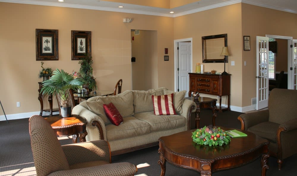 Cozy clubhouse area with a large couch and chairs at Cherokee Summit Apartments in Acworth, Georgia