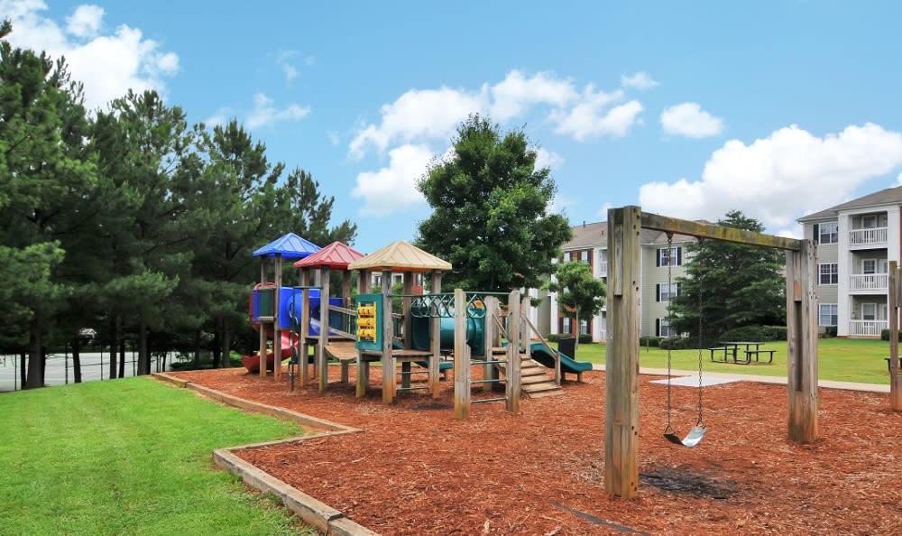 Playground and swings for children to have a blast playing on at Cherokee Summit Apartments in Acworth, Georgia