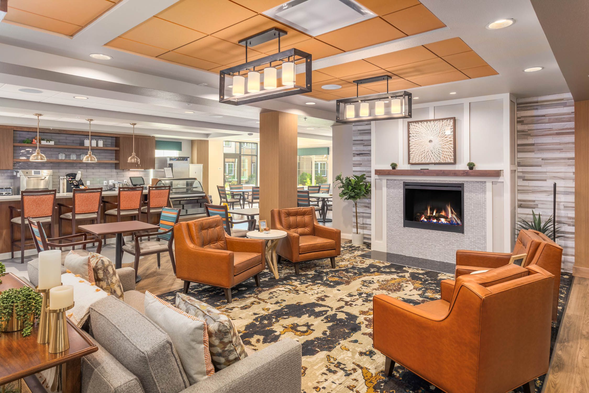Indoor seating area with fireplace at Quail Park of Lynnwood in Lynnwood, Washington