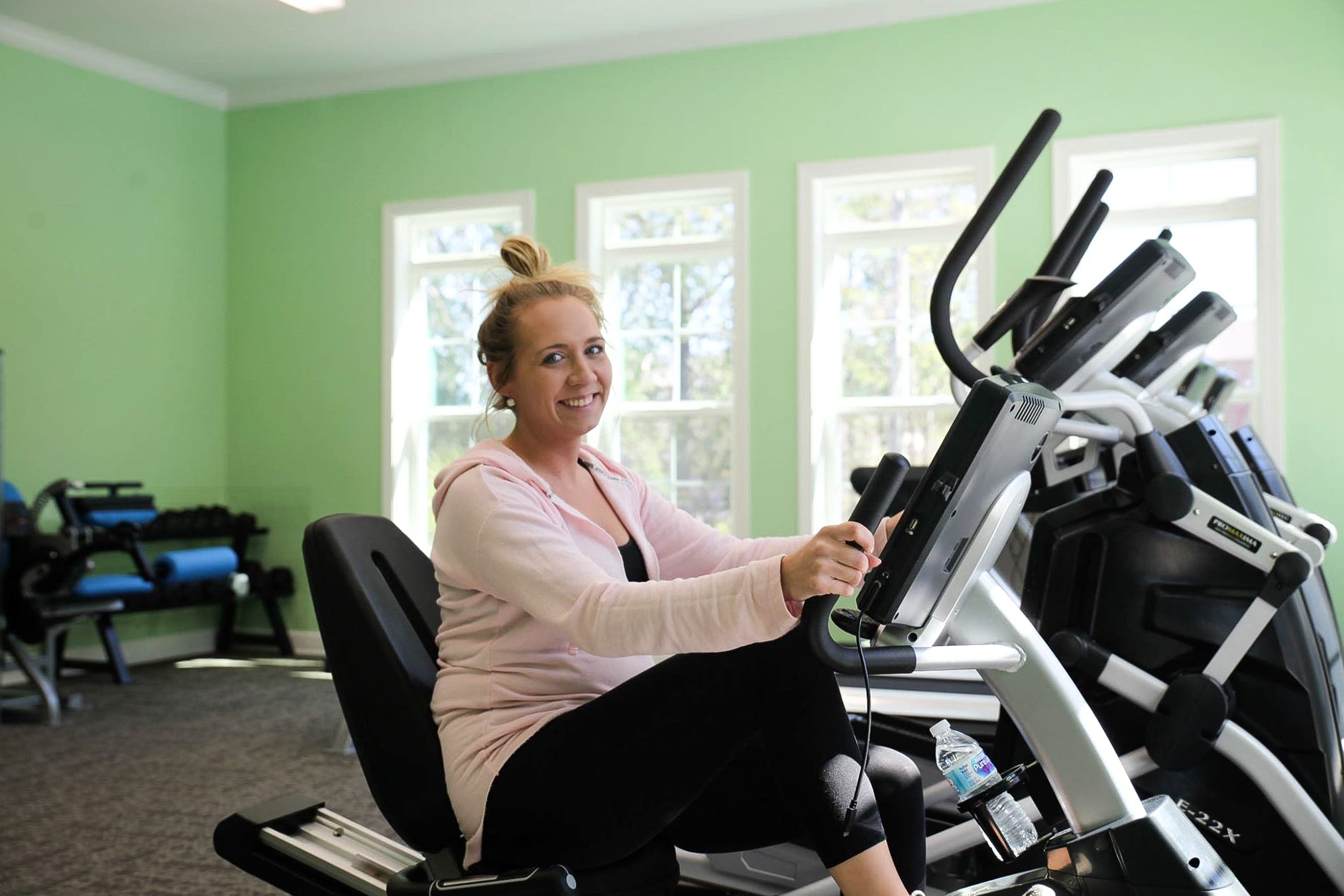 A resident exercising in the State-of-the-Art Fitness Center at La Maison Of Saraland in Saraland, Alabama