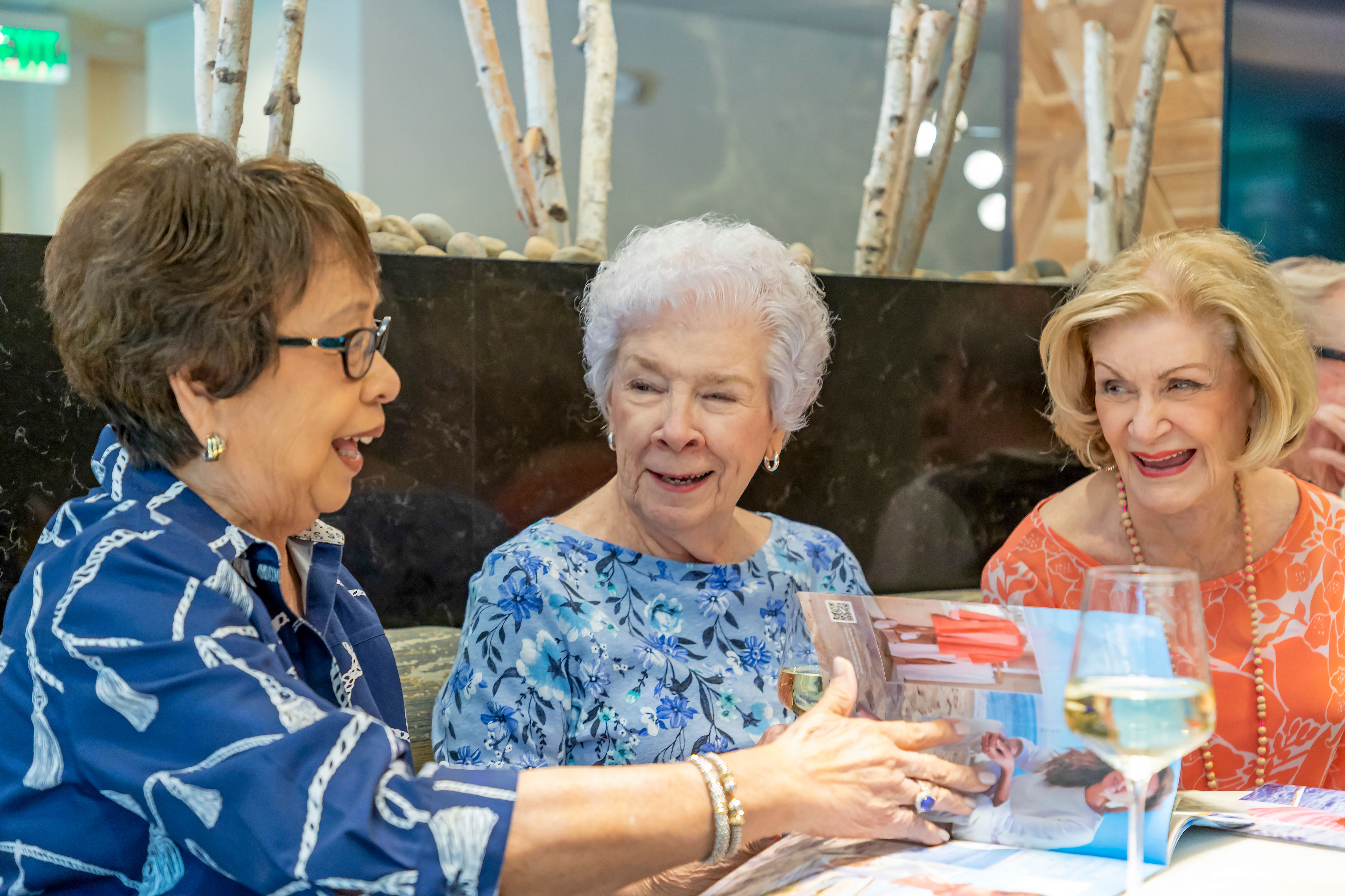 Residents laughing together during breakfast at Anthology of Novi in Novi, Michigan