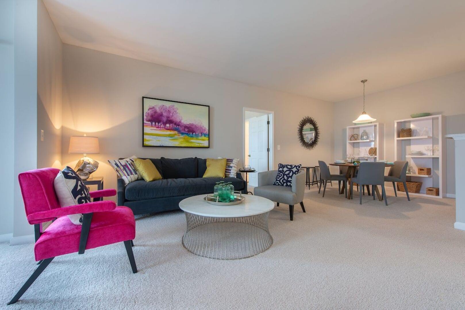 An open living space featuring stylish living area and dining space at The Elms at Germantown in Germantown, Maryland