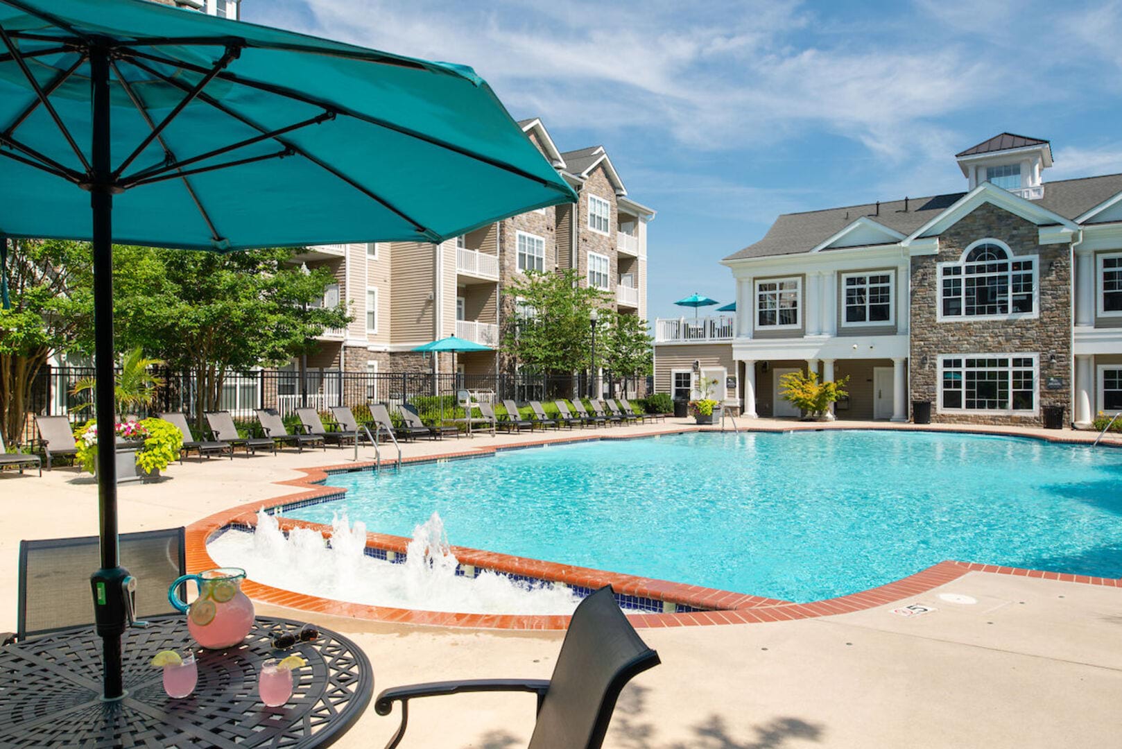 Resort-style swimming pool with sundecks at The Elms at Stoney Run Village in Hanover, Maryland