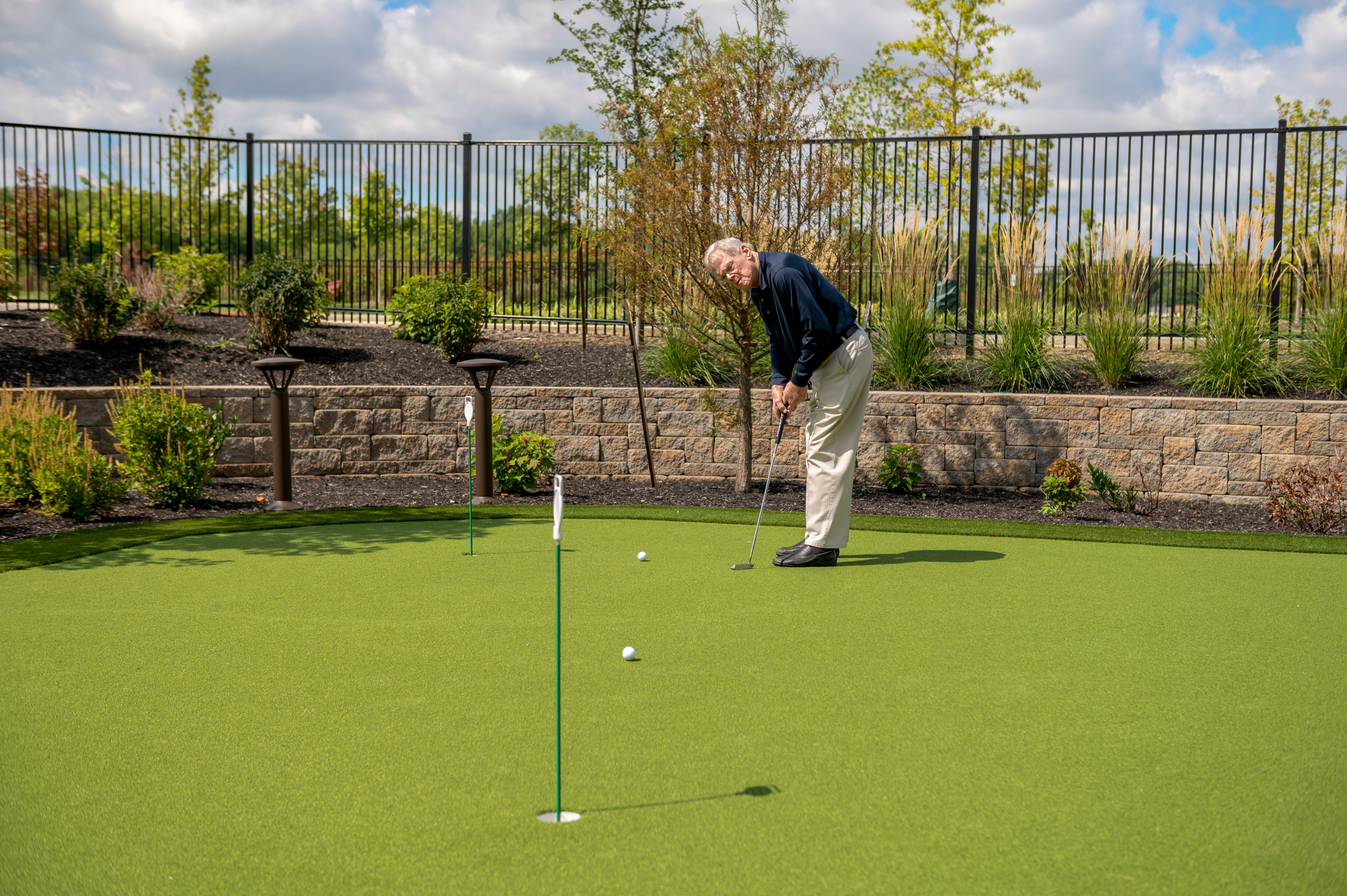 Person putting on a well manicured putting green