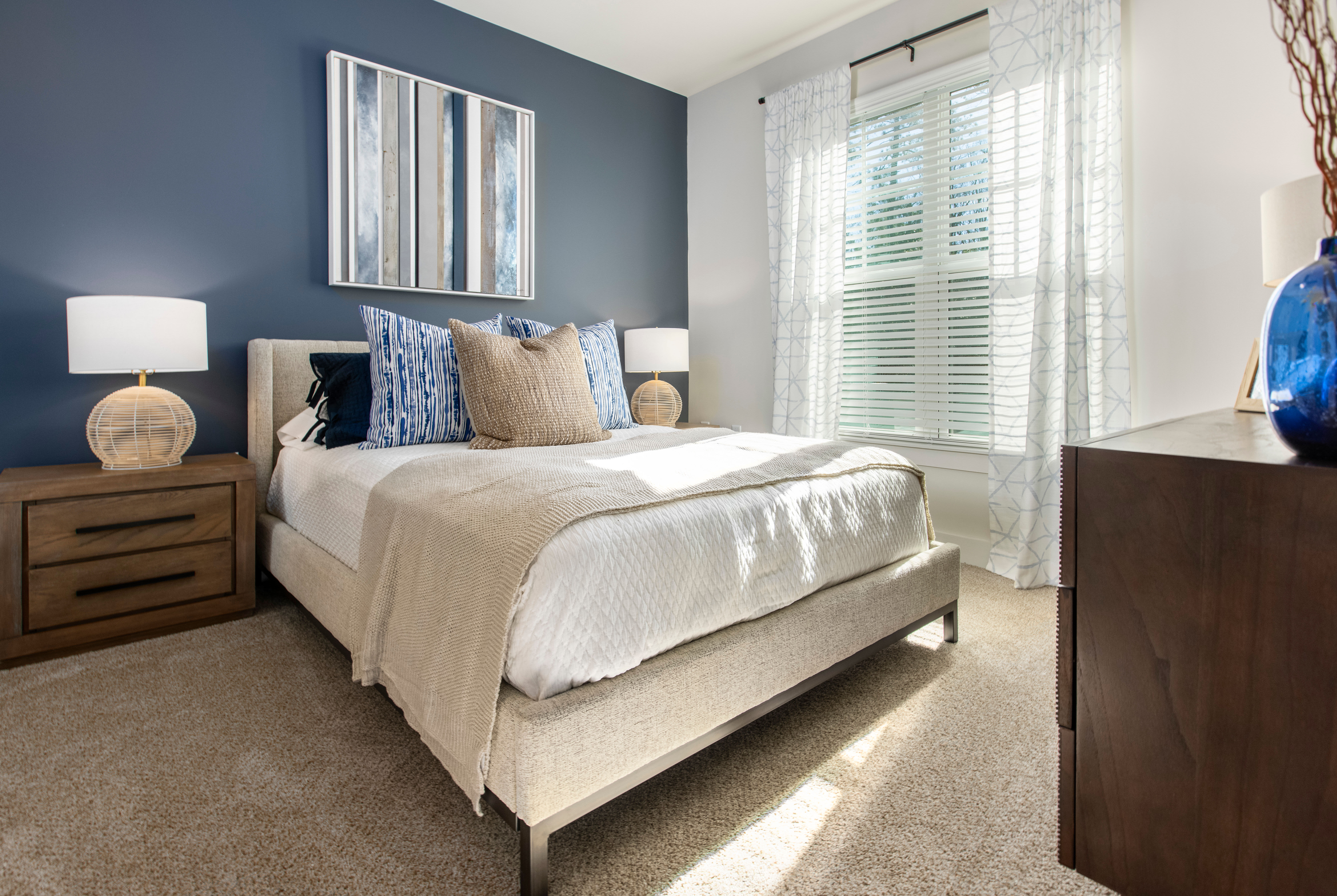 Brightly lit model bedroom at South City Apartments in Summerville, South Carolina