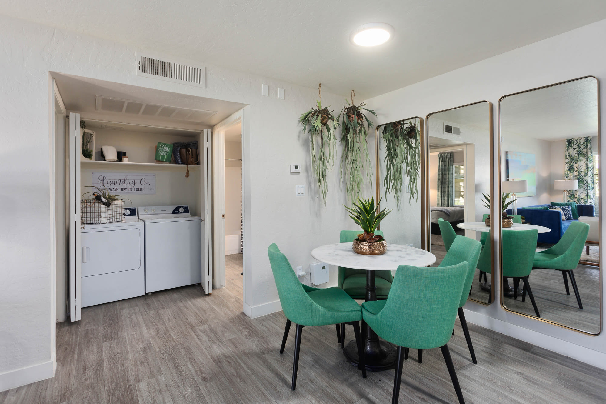 Dining area with peek at laundry room at Crestone at Shadow Mountain in Phoenix, Arizona