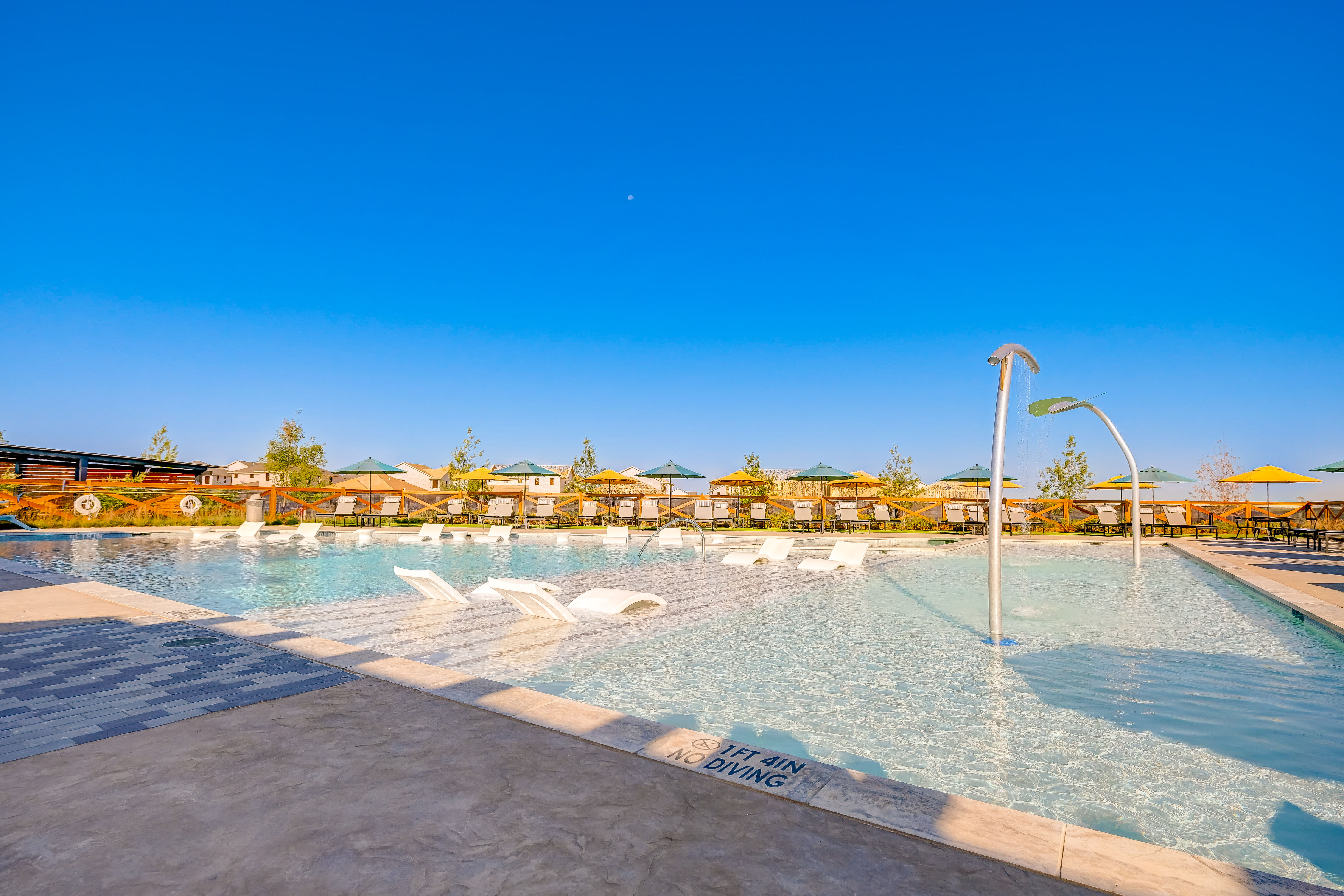 Resort style swimming Pool and splash pad at BB Living Light Farms in Celina, Texas