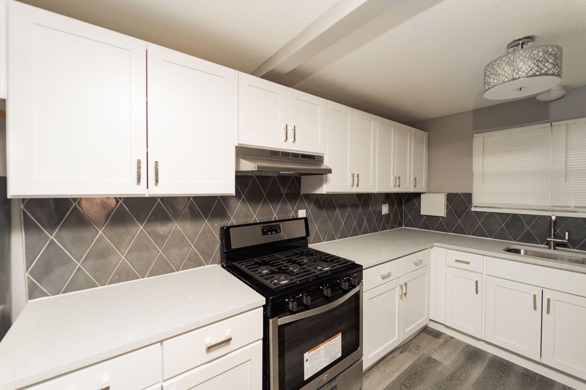 Kitchen with tiled backsplash and stainless steel appliances at Bayshore Apartments in East Haven, Connecticut