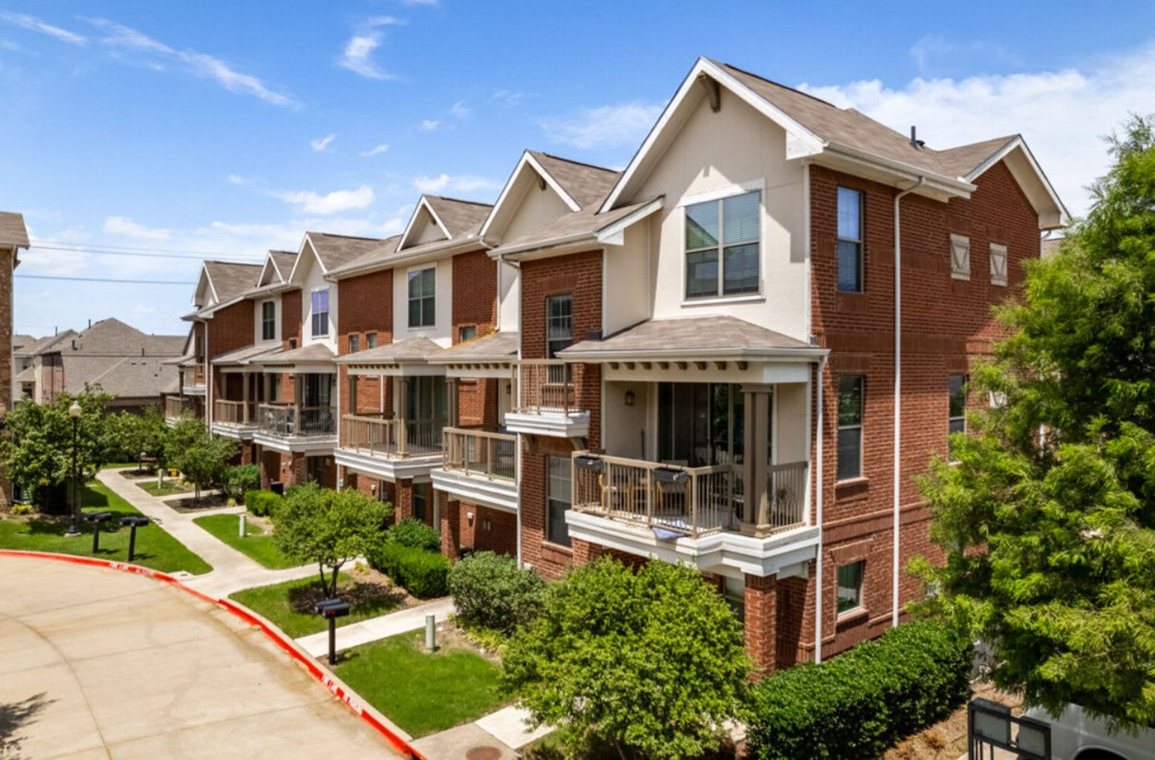 Townhome exteriors with balconies at Parkside Towns in Richardson, Texas