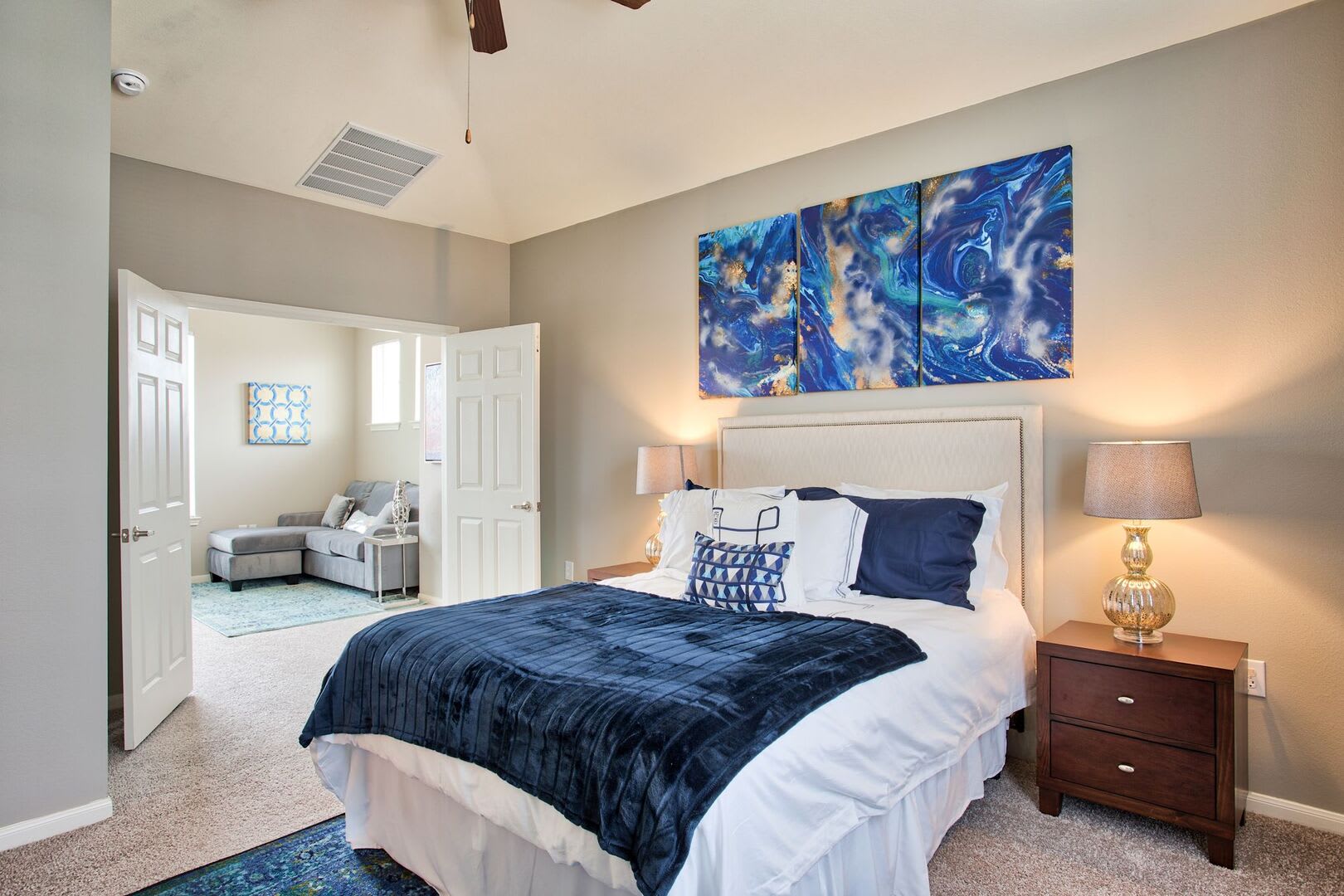 Retro-modern furniture and classic decor in a model home's bedroom at Parkside Towns in Richardson, Texas