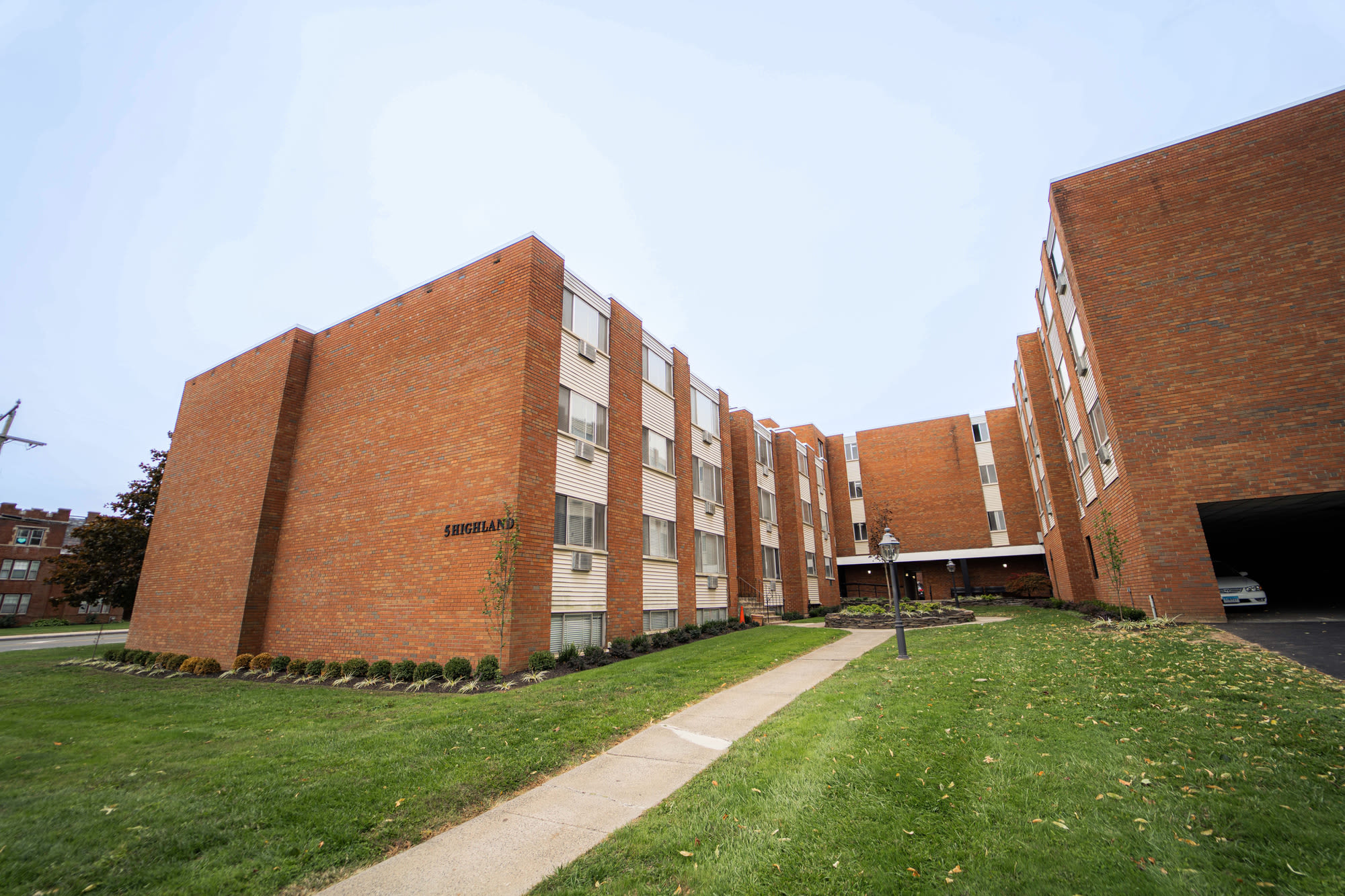Exterior view and greenspace with path at  FiveHigh in West Hartford, Connecticut