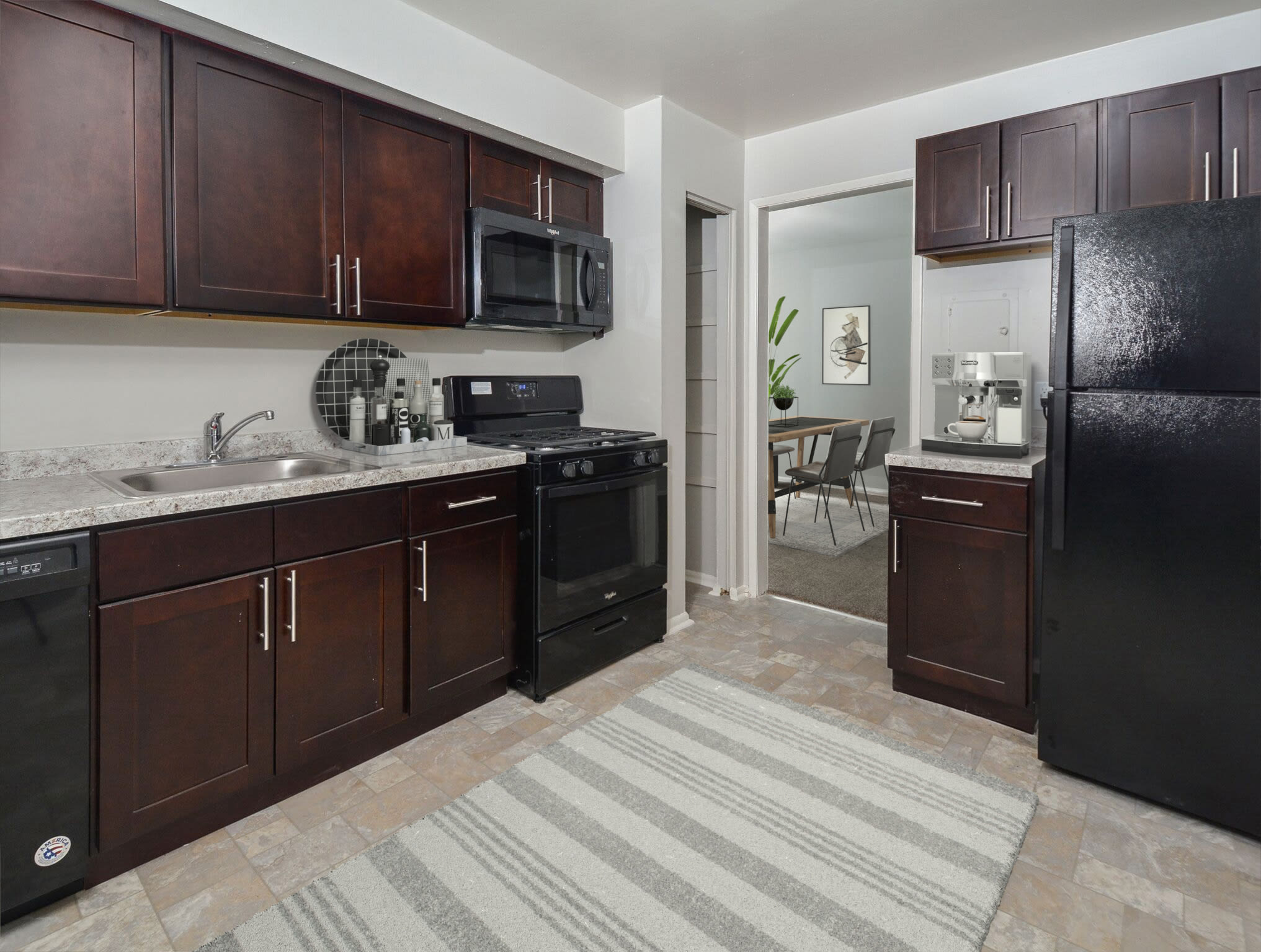 Model kitchen with wood cabinets at Metro Pointe, Baltimore, Maryland