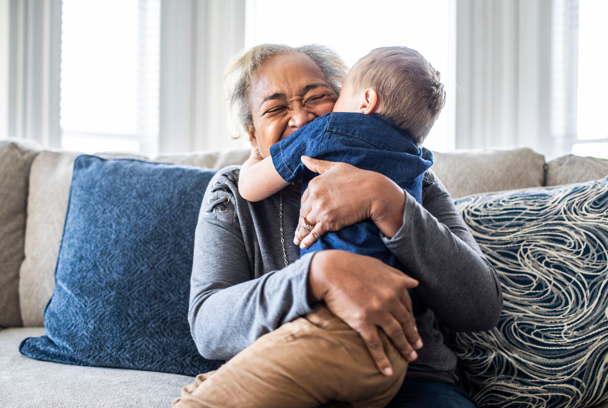 Grandparent hugging a child on a couch at Attivo Trail in Ames, Iowa