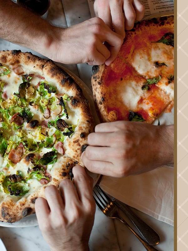 Residents enjoying some delicious looking pizza near The Mallory in Raleigh, North Carolina