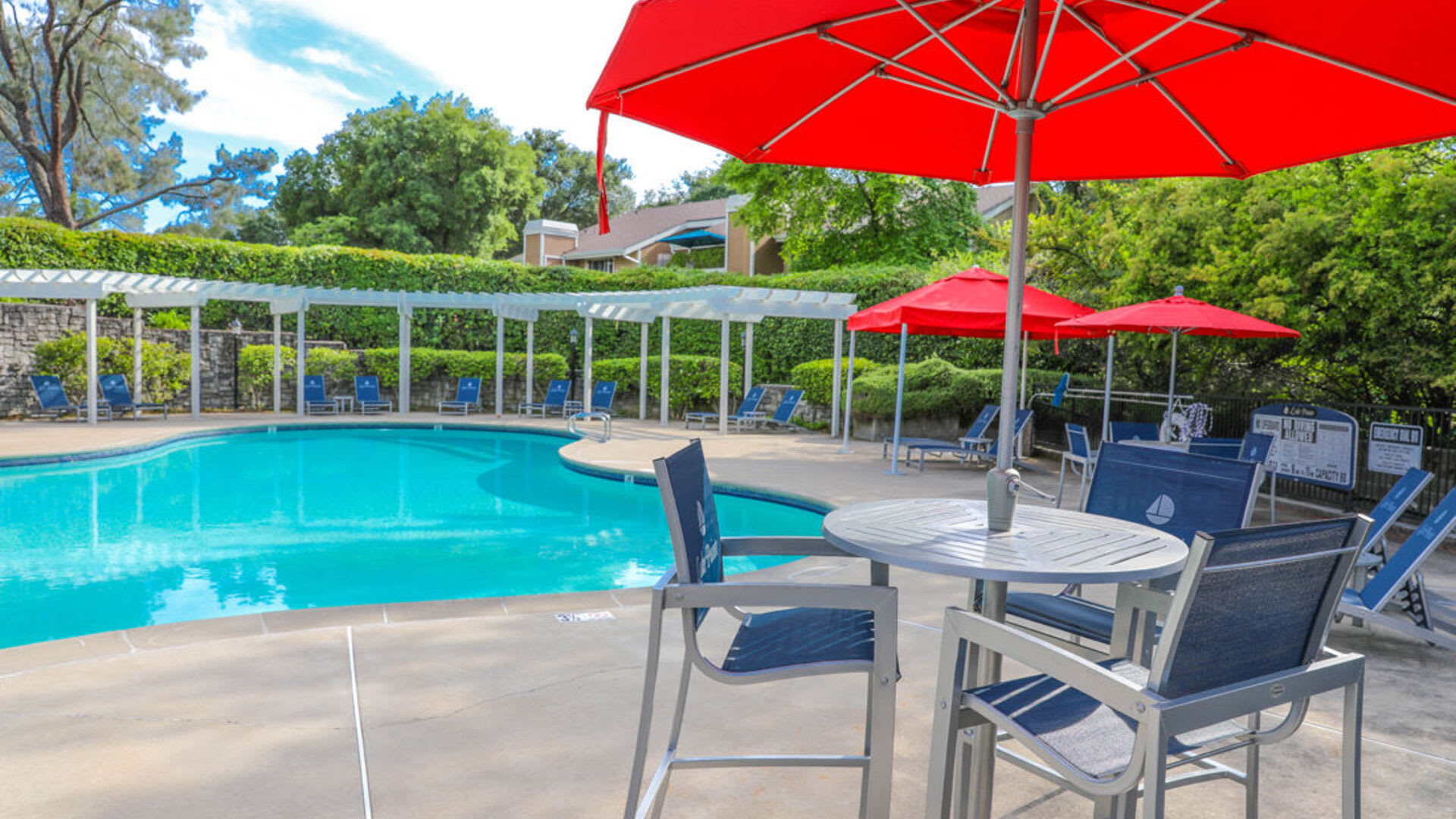 Swimming pool with umbrellas at Lake Pointe Apartments in Folsom, California