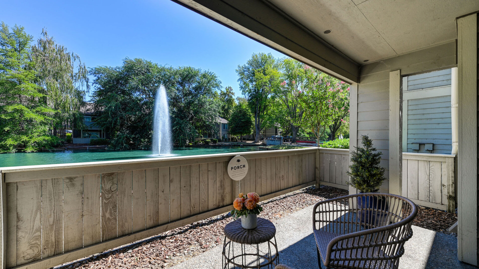 Private patio with waterfront views at Harbor Oaks Apartments in Sacramento, California