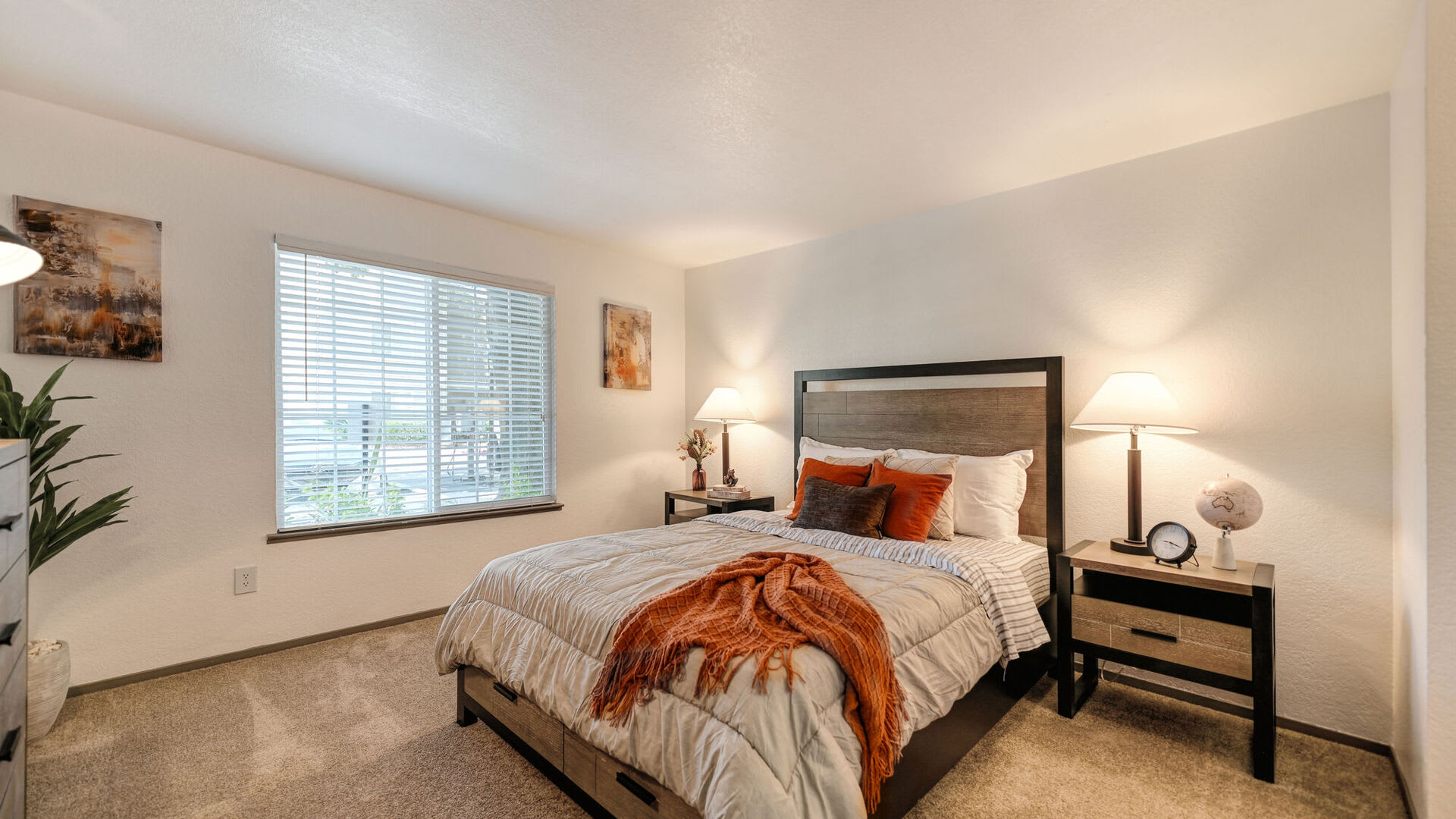 Model bedroom with natural light at Harbor Oaks Apartments in Sacramento, California