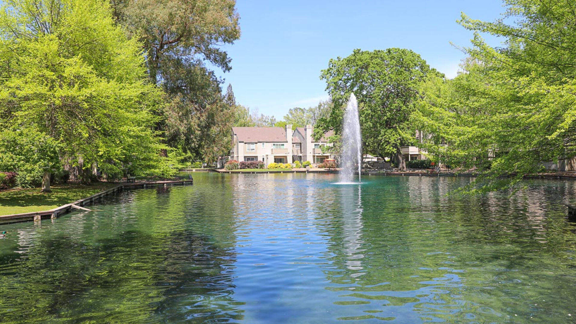 Waterfront with fountain at Harbor Oaks Apartments in Sacramento, California